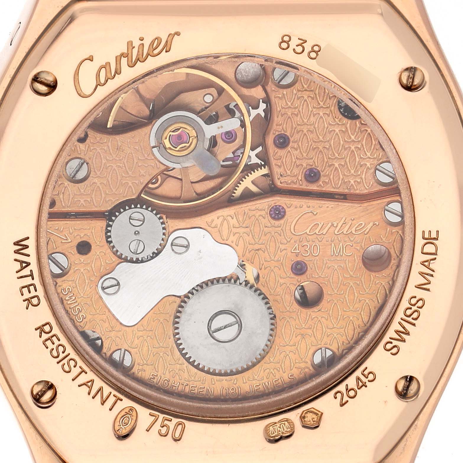 The image shows the open case back of a Cartier Tortue WA507031 Women's Rose Gold Silver Dial watch, displaying its intricate mechanical movement and engravings.