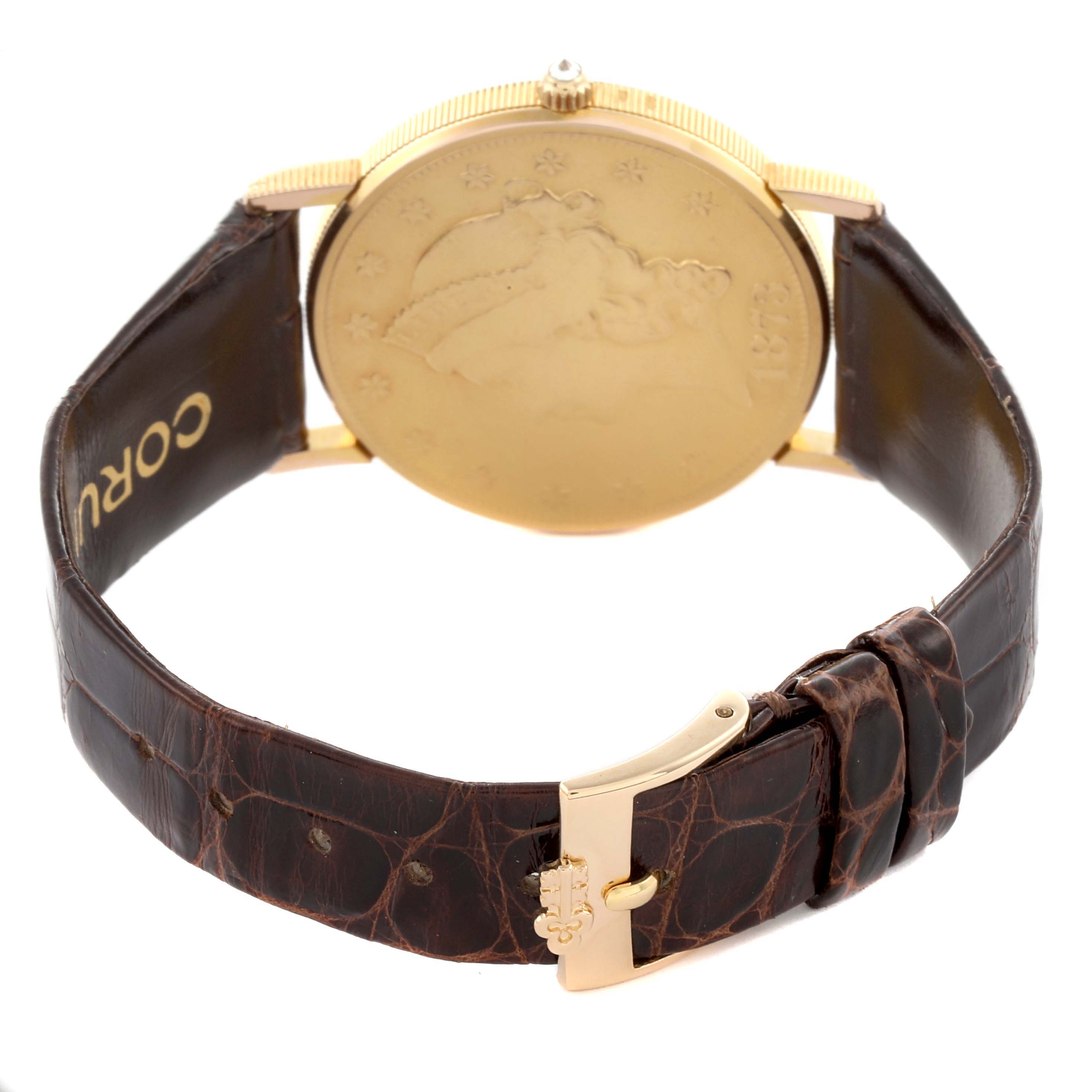 The Corum Coin Watch 4414556 Men's Yellow Gold Champagne Dial 4414556 Men's Yellow Gold Champagne Dial is shown from the back, highlighting its gold case and brown leather strap with buckle.