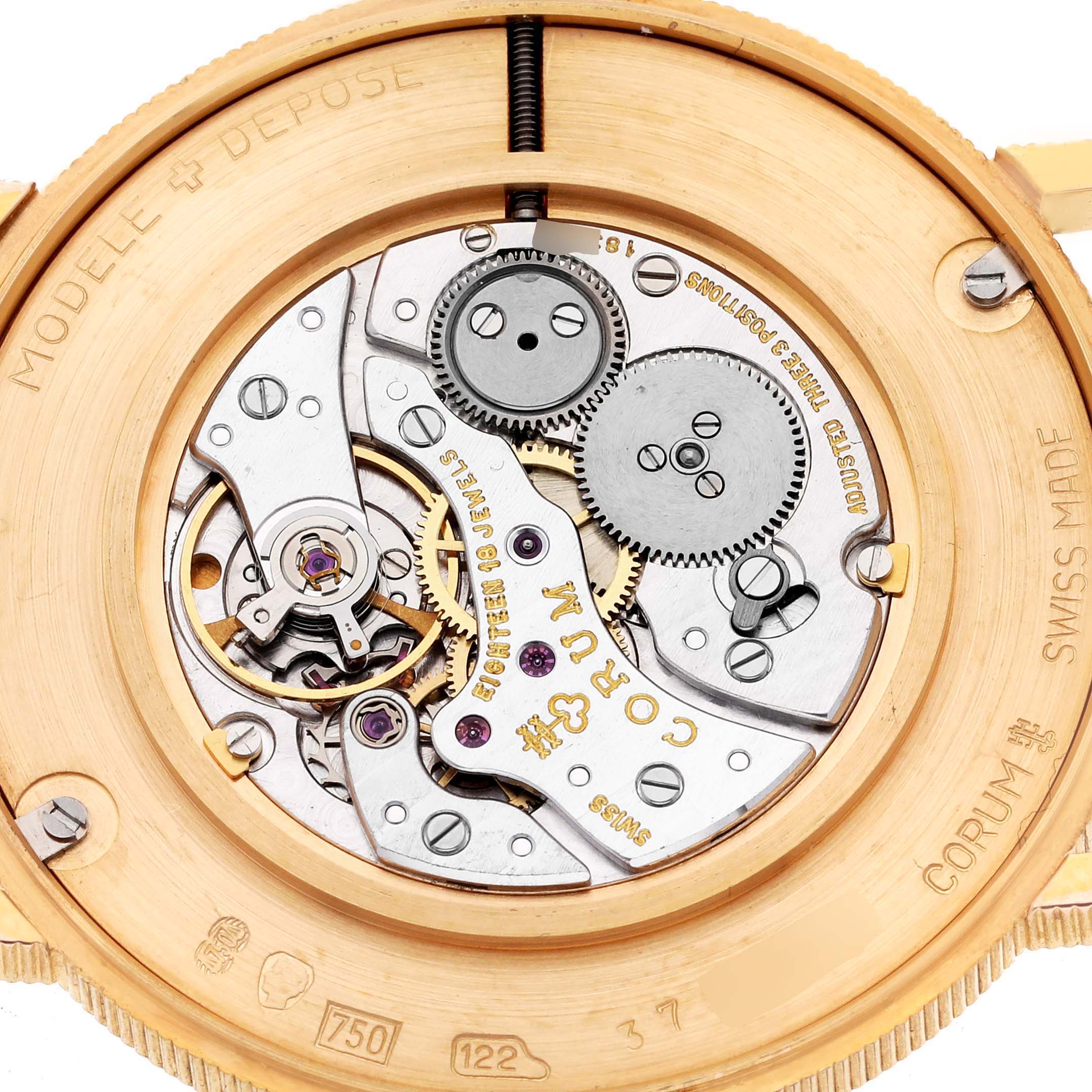 The image shows a close-up view of the movement inside a Corum Coin Watch 4414556 Men's Yellow Gold Champagne Dial 4414556 Men's Yellow Gold Champagne Dial, highlighting gears and engravings.