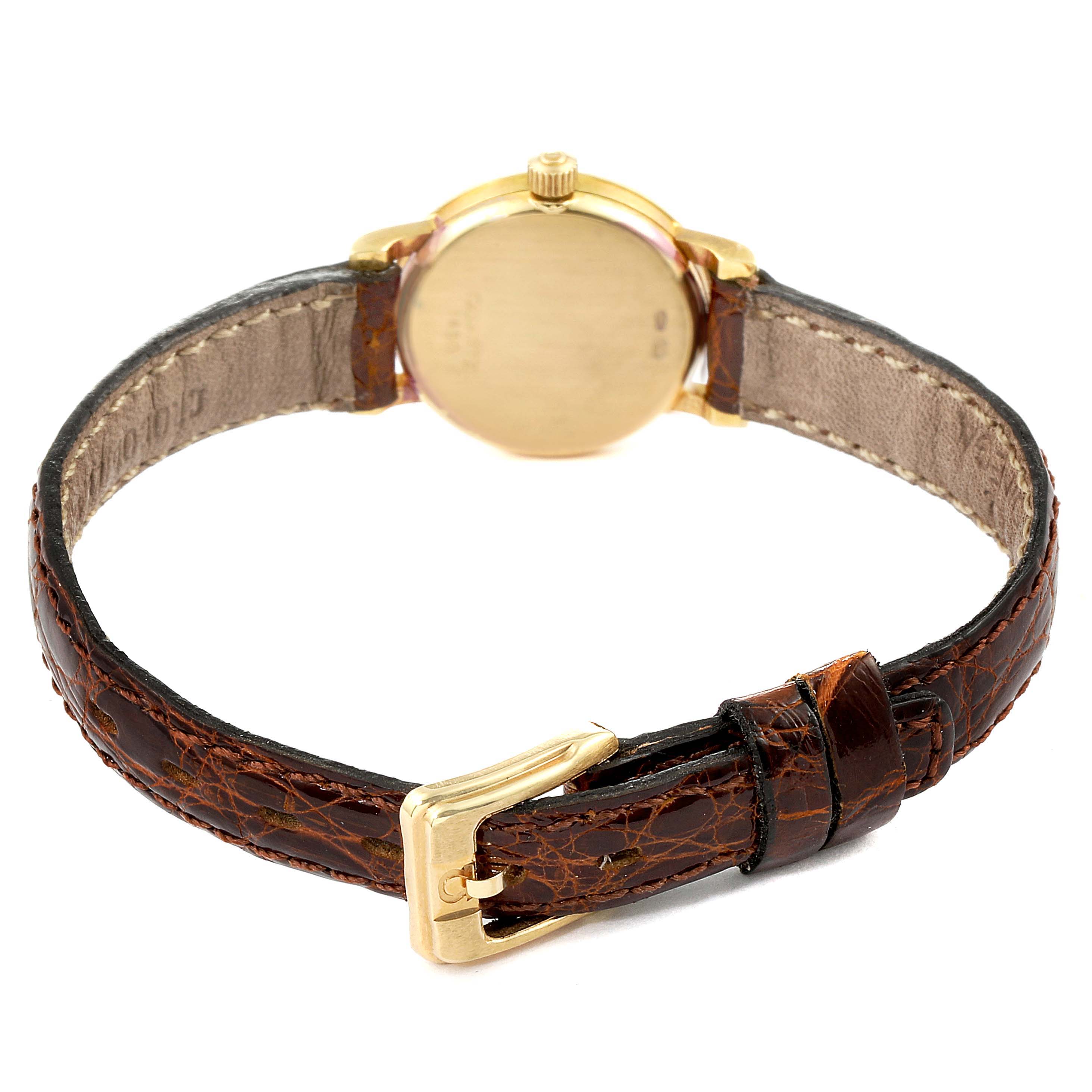 The rear view of the Omega 1450 Women's Yellow Gold Champagne Dial 1450 Women's Yellow Gold Champagne Dial DeVille Mini Yellow Gold Diamond Cocktail Ladies Watch 1450 Unworn shows the back case and leather strap with buckle.