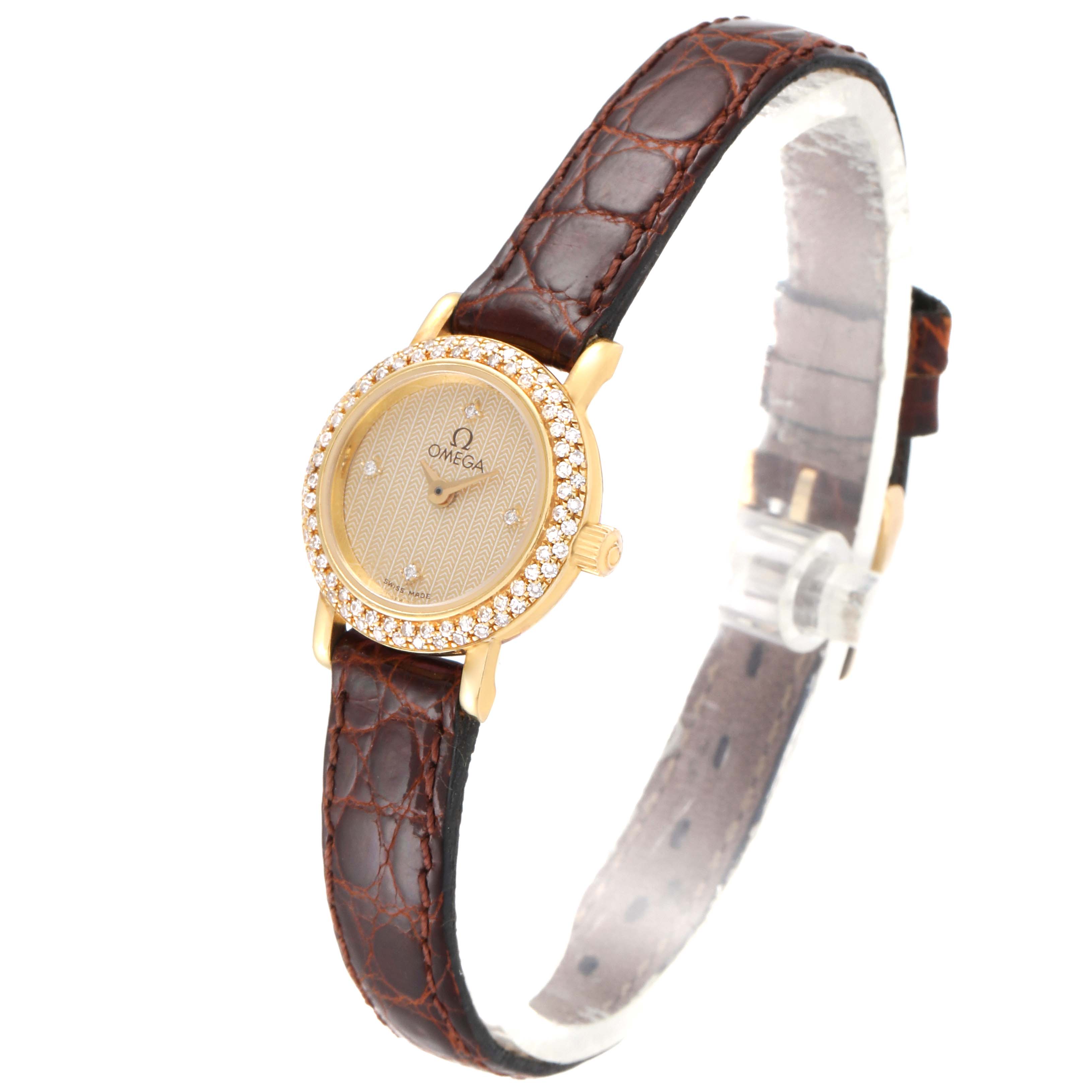 This image shows an angled view of the Omega 1450 Women's Yellow Gold Champagne Dial 1450 Women's Yellow Gold Champagne Dial DeVille Mini Yellow Gold Diamond Cocktail Ladies Watch 1450 Unworn model, highlighting its face and strap.