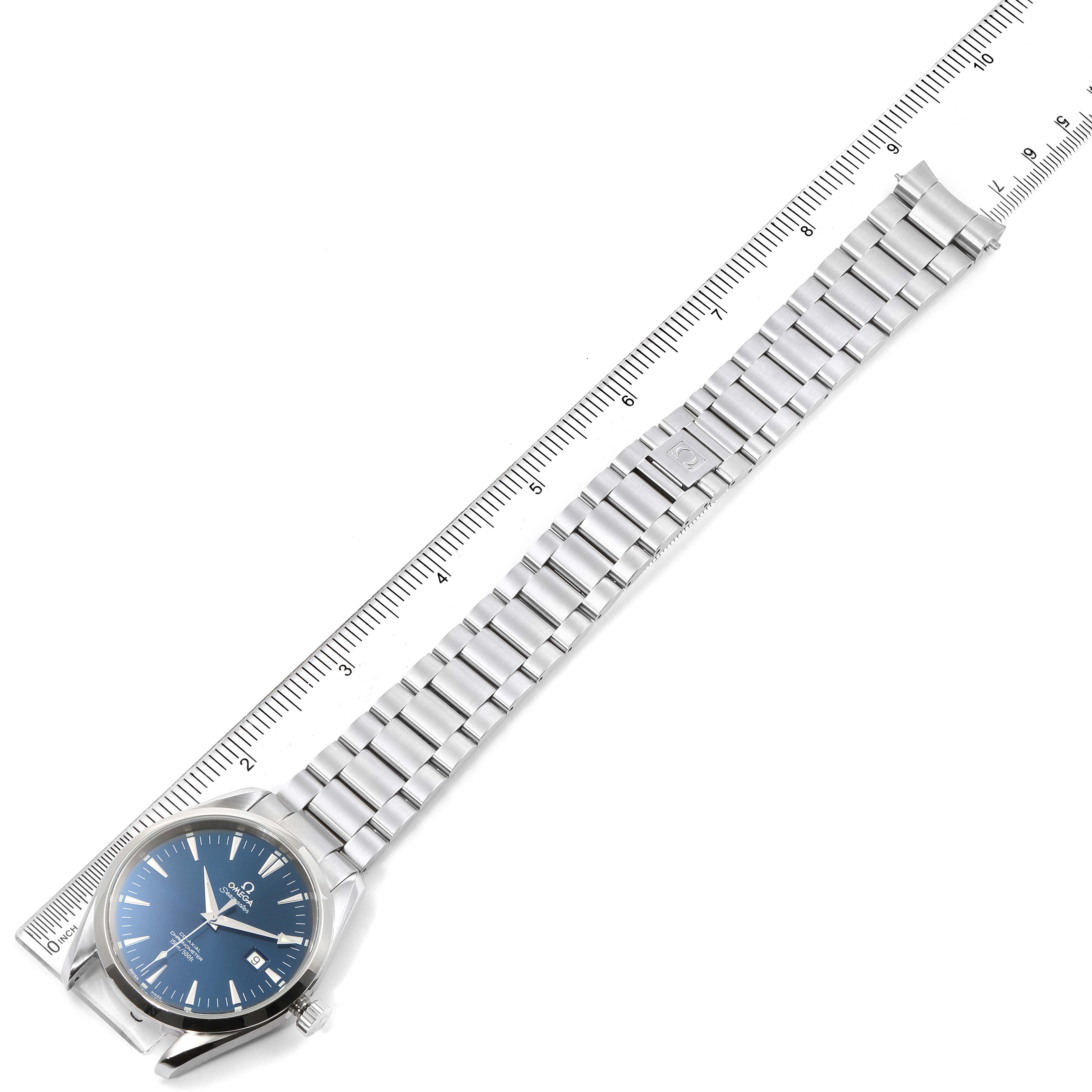 The image shows an Omega Aqua Terra 2502.80.00 Men
s Stainless Steel Blue Dial 2502.80.00 Men
s Stainless Steel Blue Dial watch laid flat with its full stainless steel bracelet extended next to a ruler.