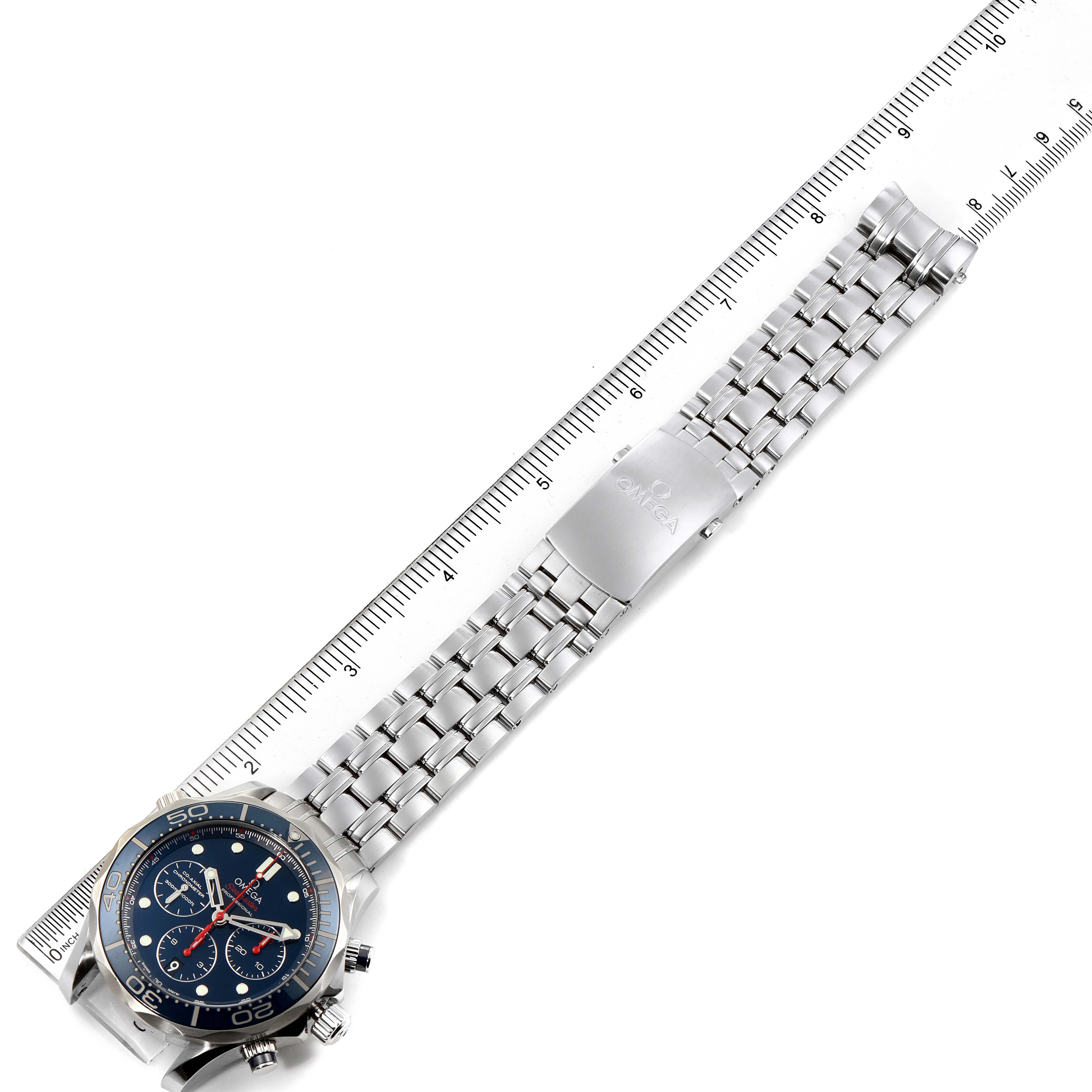 The image shows the Omega Seamaster 212.30.44.50.03.001 Men's Stainless Steel Blue Dial 212.30.44.50.03.001 Men's Stainless Steel Blue Dial watch laid flat with its stainless steel bracelet against a ruler for measurement.