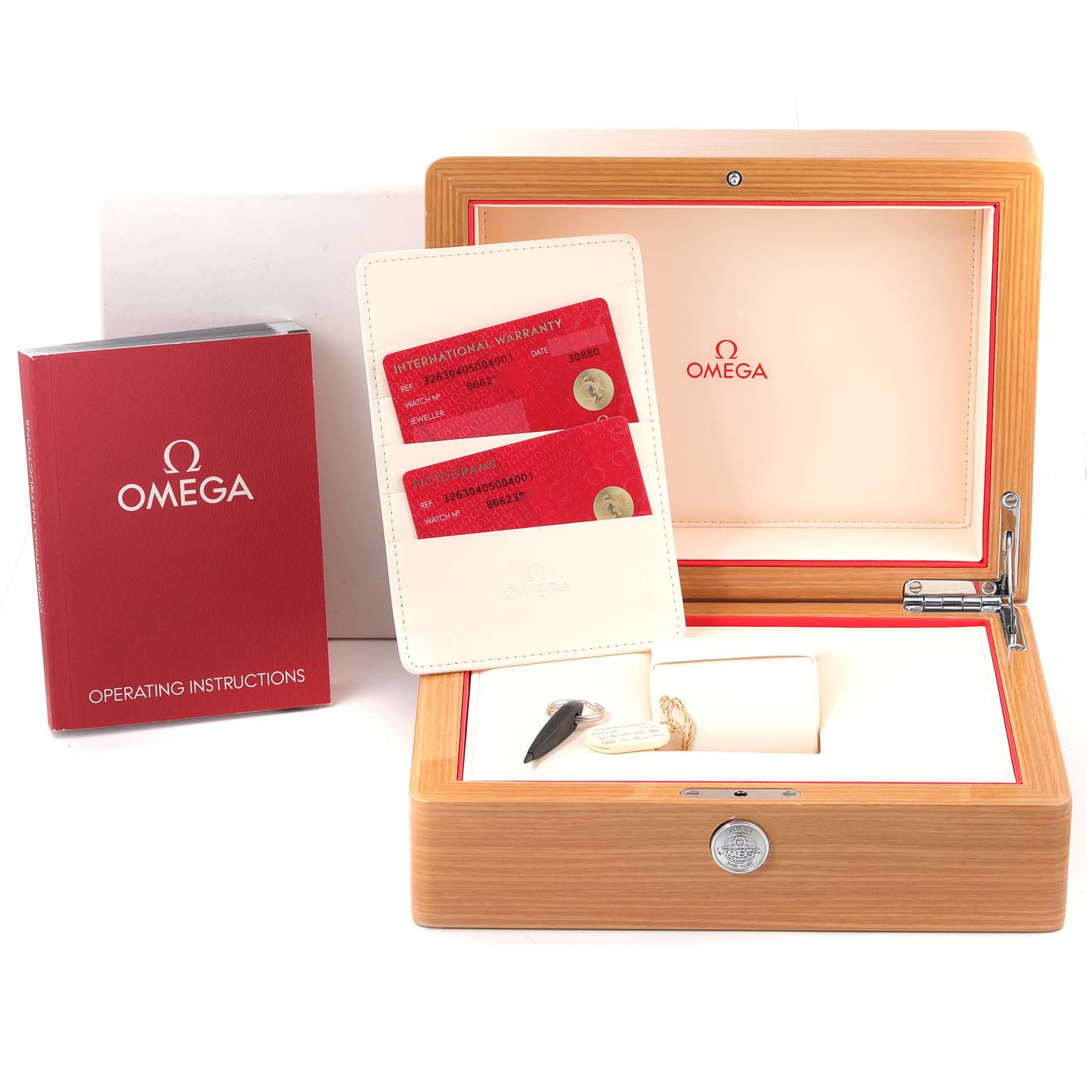 The image shows the Omega Speedmaster 326.30.40.50.04.001 Men
s Stainless Steel White Dial 326.30.40.50.04.001 Men
s Stainless Steel White Dial watch packaging, including the warranty cards, operating instructions, and wooden box.