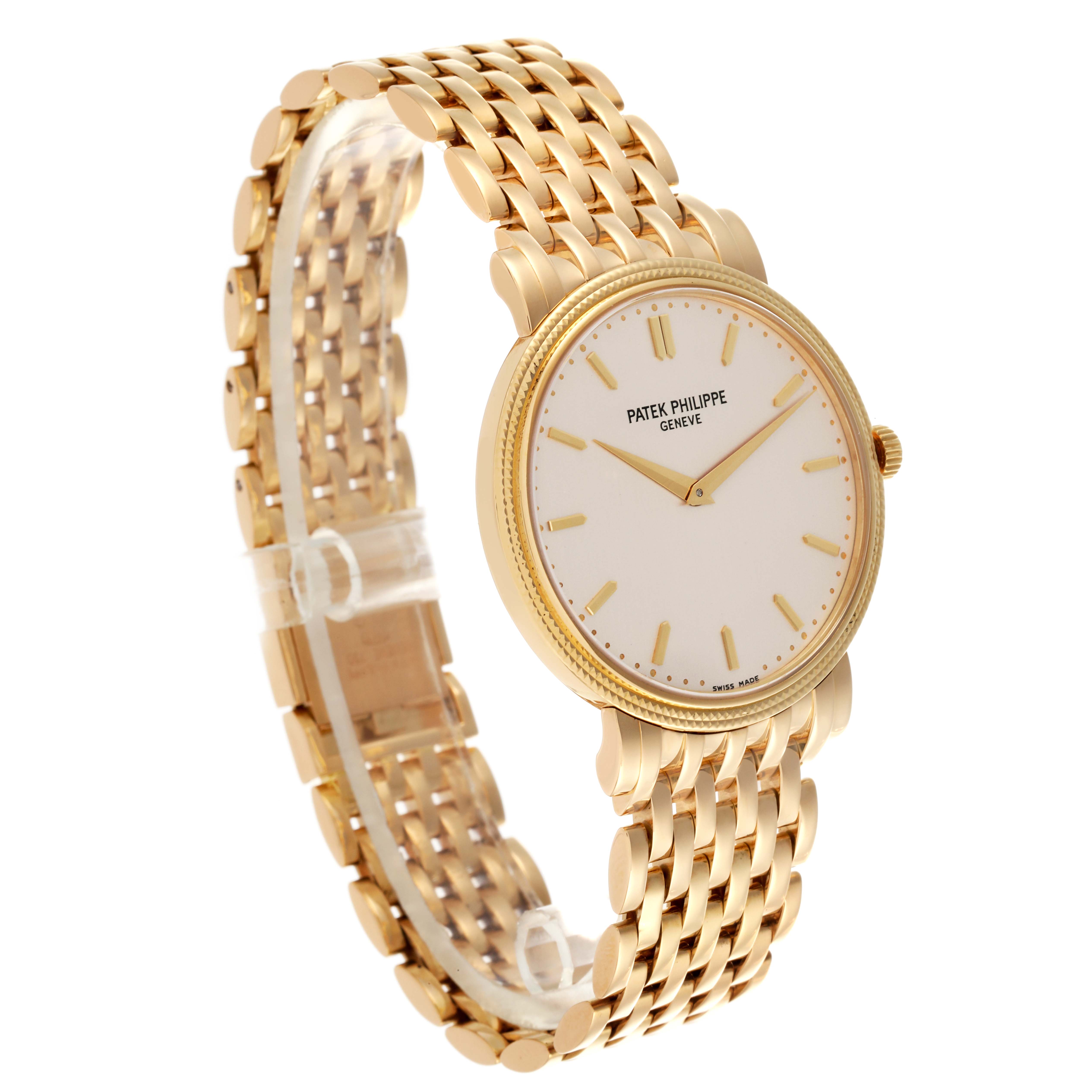 The Patek Philippe Calatrava 5120/1J-001 Men's Yellow Gold Silver Dial 5120/1J-001 Men's Yellow Gold Silver Dial watch is shown at a slight angle highlighting the face and gold bracelet.