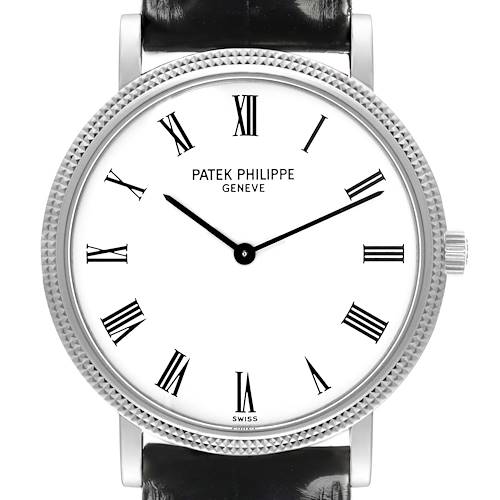 The Patek Philippe Calatrava is shown from a front angle, highlighting its dial, bezel, and crown.