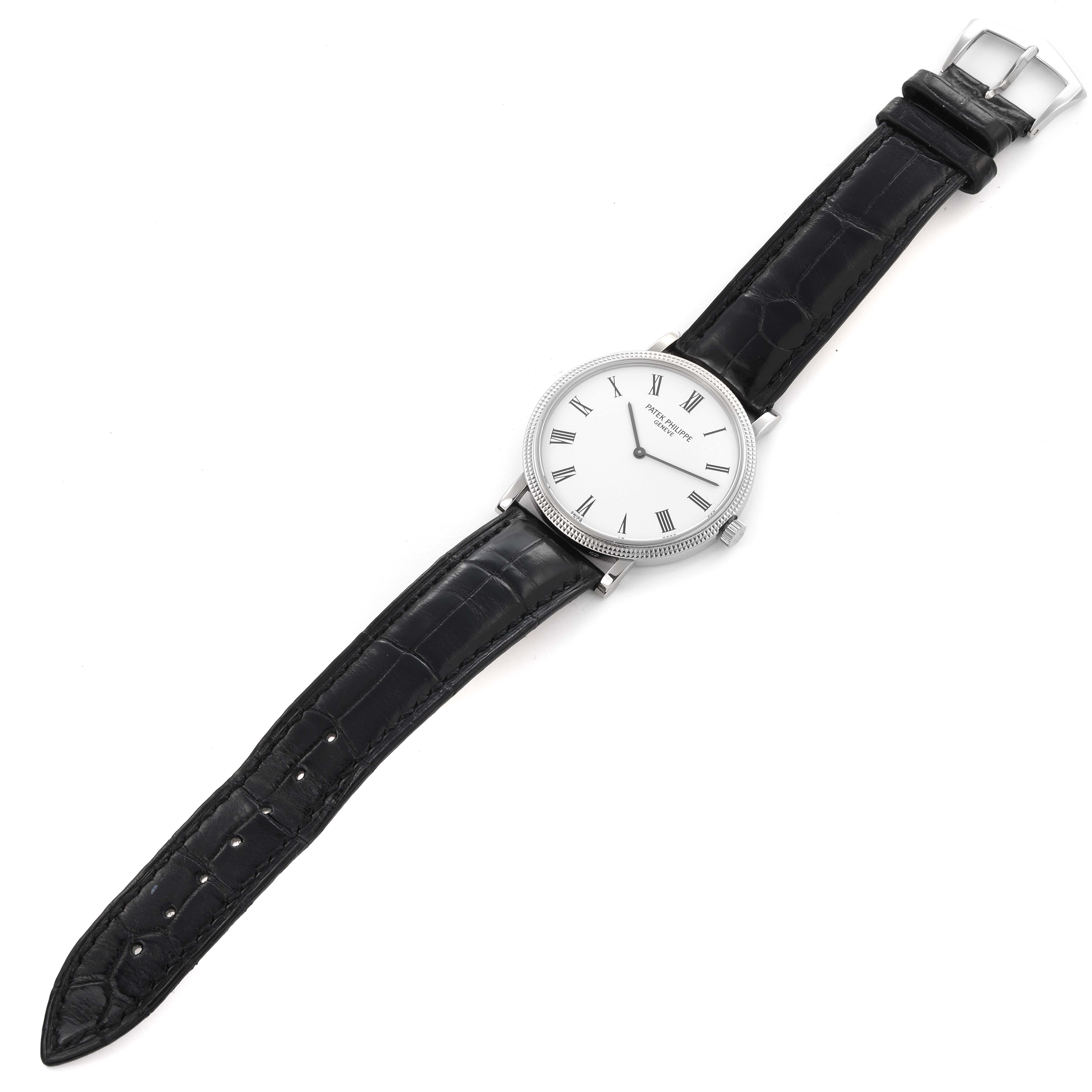 The Patek Philippe Calatrava 5120G Men's White Gold White Dial 5120G Men's White Gold White Dial watch is shown from a top-down angle, displaying the face, case, and full black leather strap.