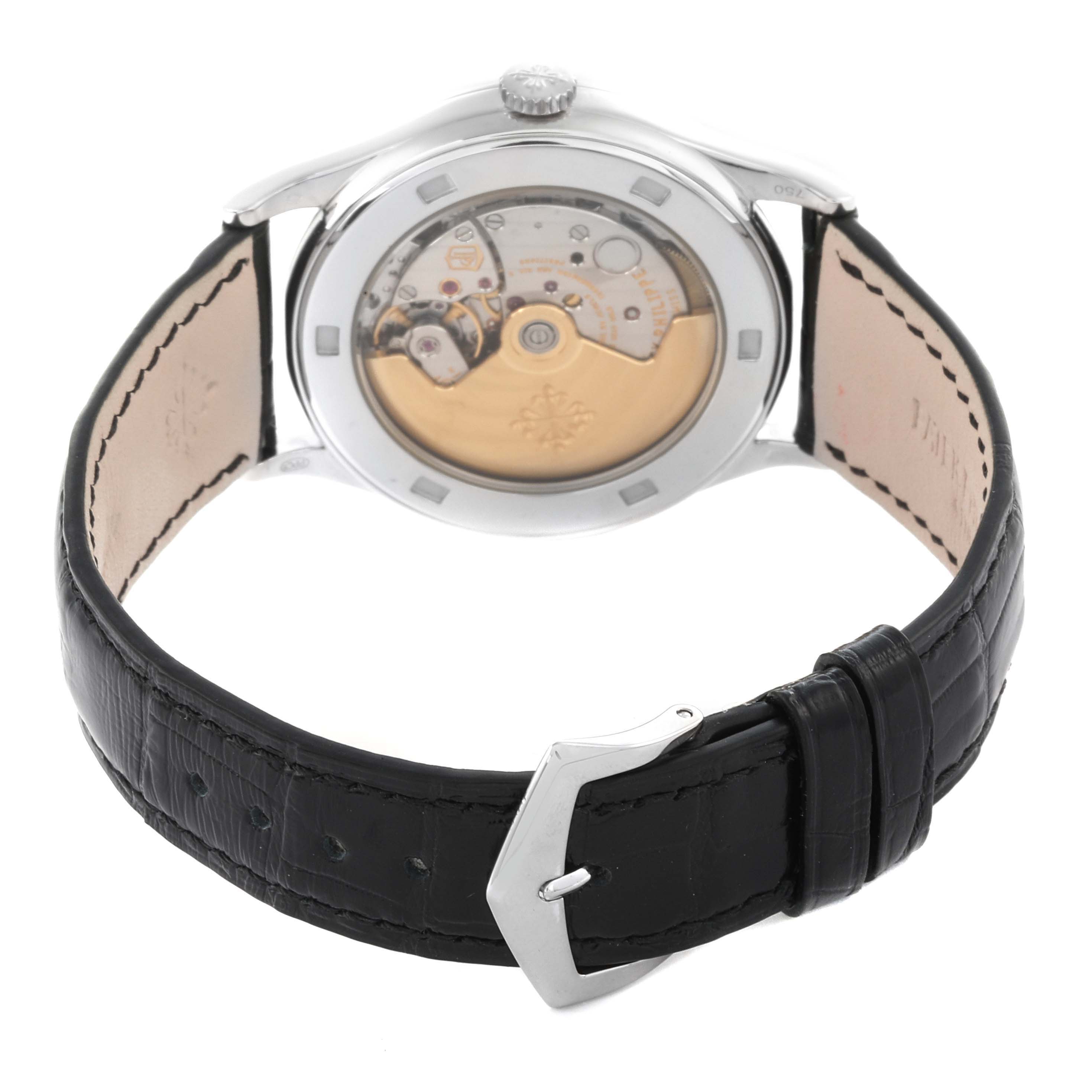 The image shows the back view of a Patek Philippe Calatrava 5297G-001 Men's White Gold Black Dial 5297G-001 Men's White Gold Black Dial watch, highlighting its open case back and black leather strap.