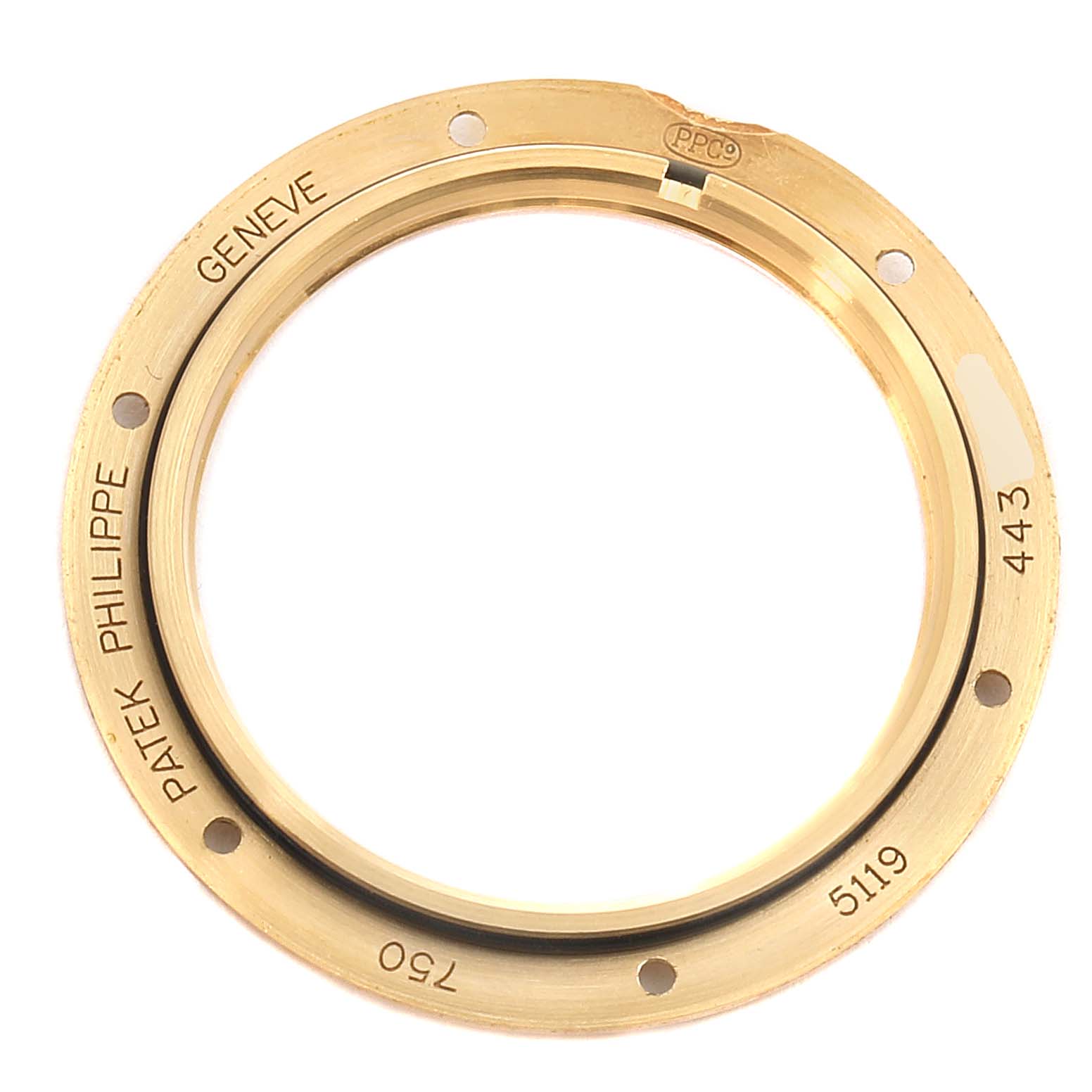 This image shows the gold bezel of a Patek Philippe Calatrava 5119J Men's Yellow Gold White Dial 5119J Men's Yellow Gold White Dial model 5119 watch, with brand engravings visible.