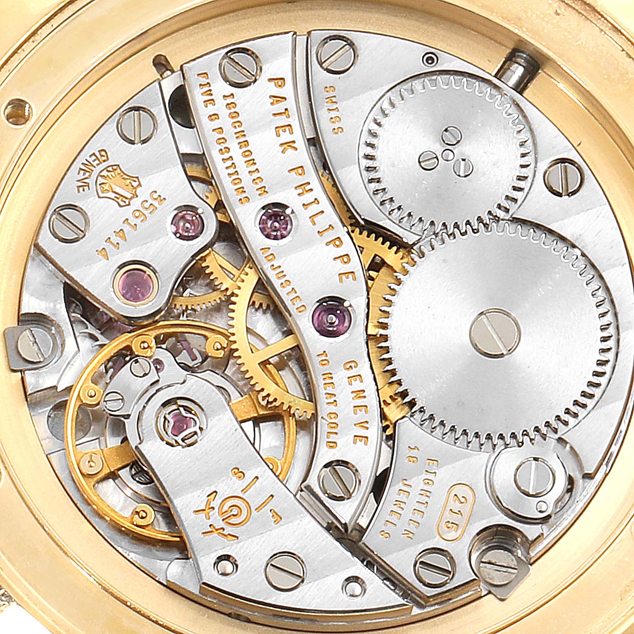 The image shows the movement mechanism of a Patek Philippe Calatrava 5119J Men's Yellow Gold White Dial 5119J Men's Yellow Gold White Dial watch, highlighting gears and intricate components.