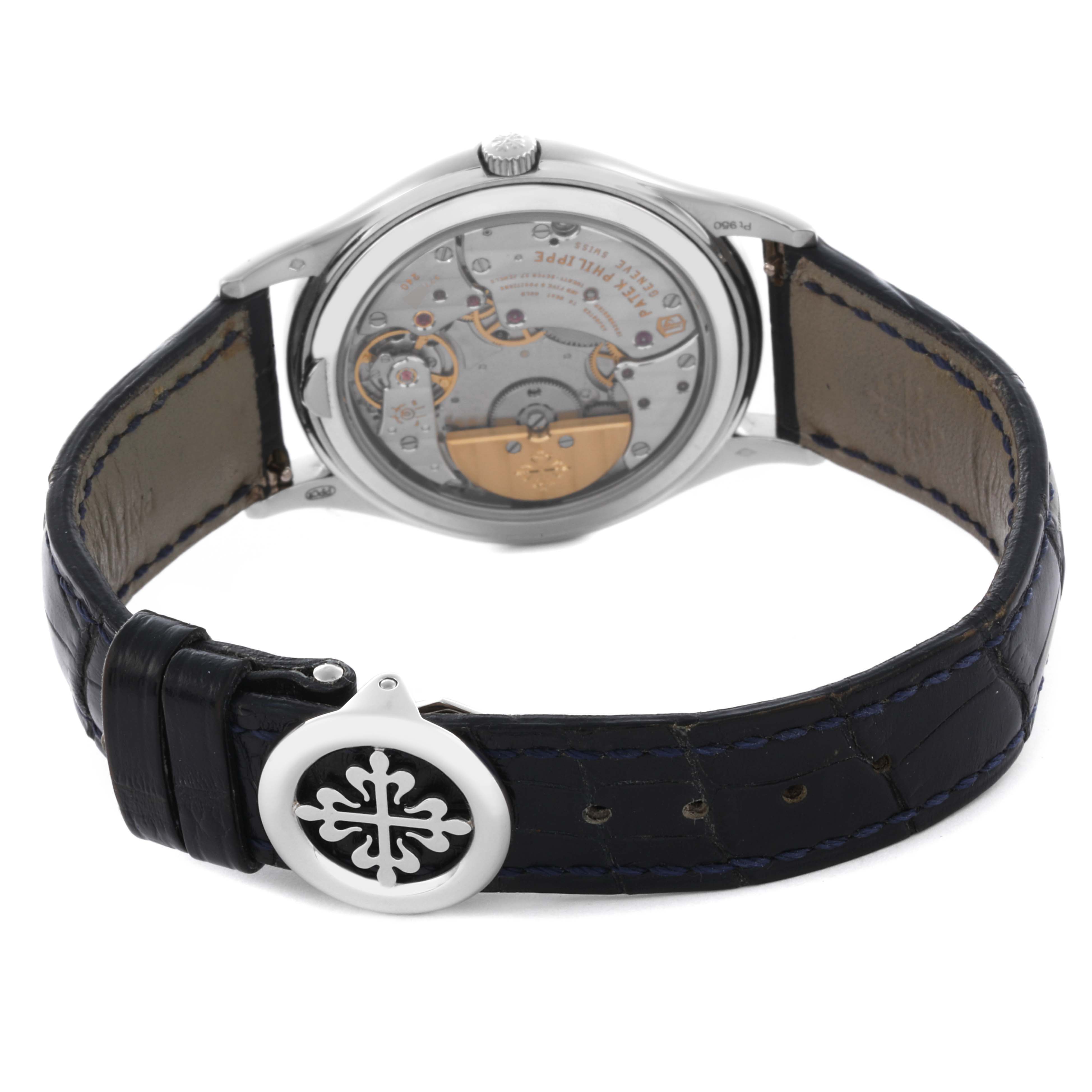The Patek Philippe Complications 5140P-001 Men's Platinum Blue Dial 5140P-001 Men's Platinum Blue Dial watch is shown from the back, displaying the movement and leather strap with a clasp.