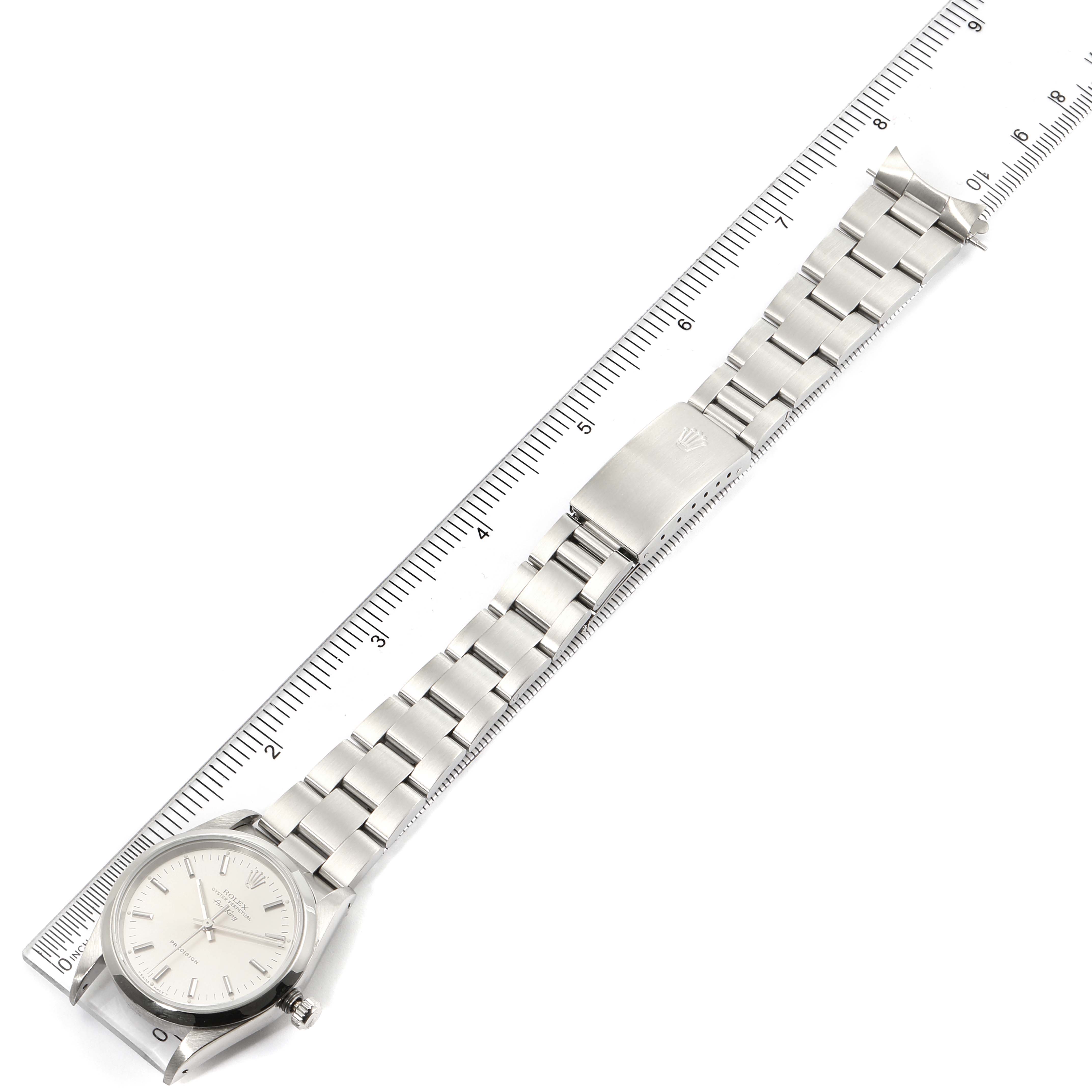 The Rolex Air-King 14000 Men's Stainless Steel Silver Dial 14000 Men's Stainless Steel Silver Dial watch is shown from an overhead angle, displaying the full length of the band and dial alongside a ruler.