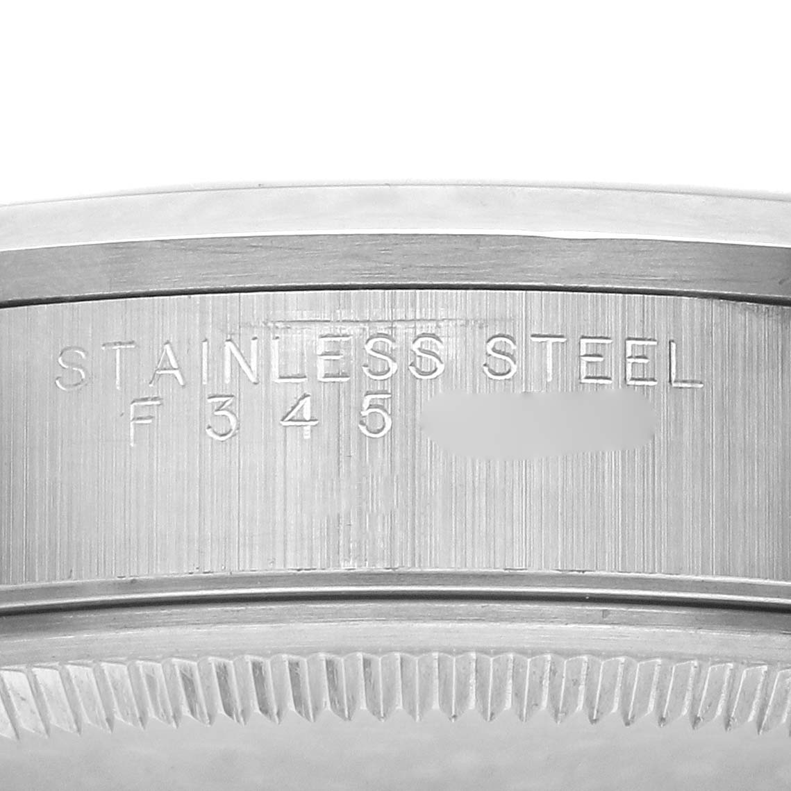 The image shows a close-up of a Rolex Air-King 14000M Men's Stainless Steel Silver Dial 14000M Men's Stainless Steel Silver Dial watch case, highlighting the engraved "STAINLESS STEEL" text and part of the bezel edge.