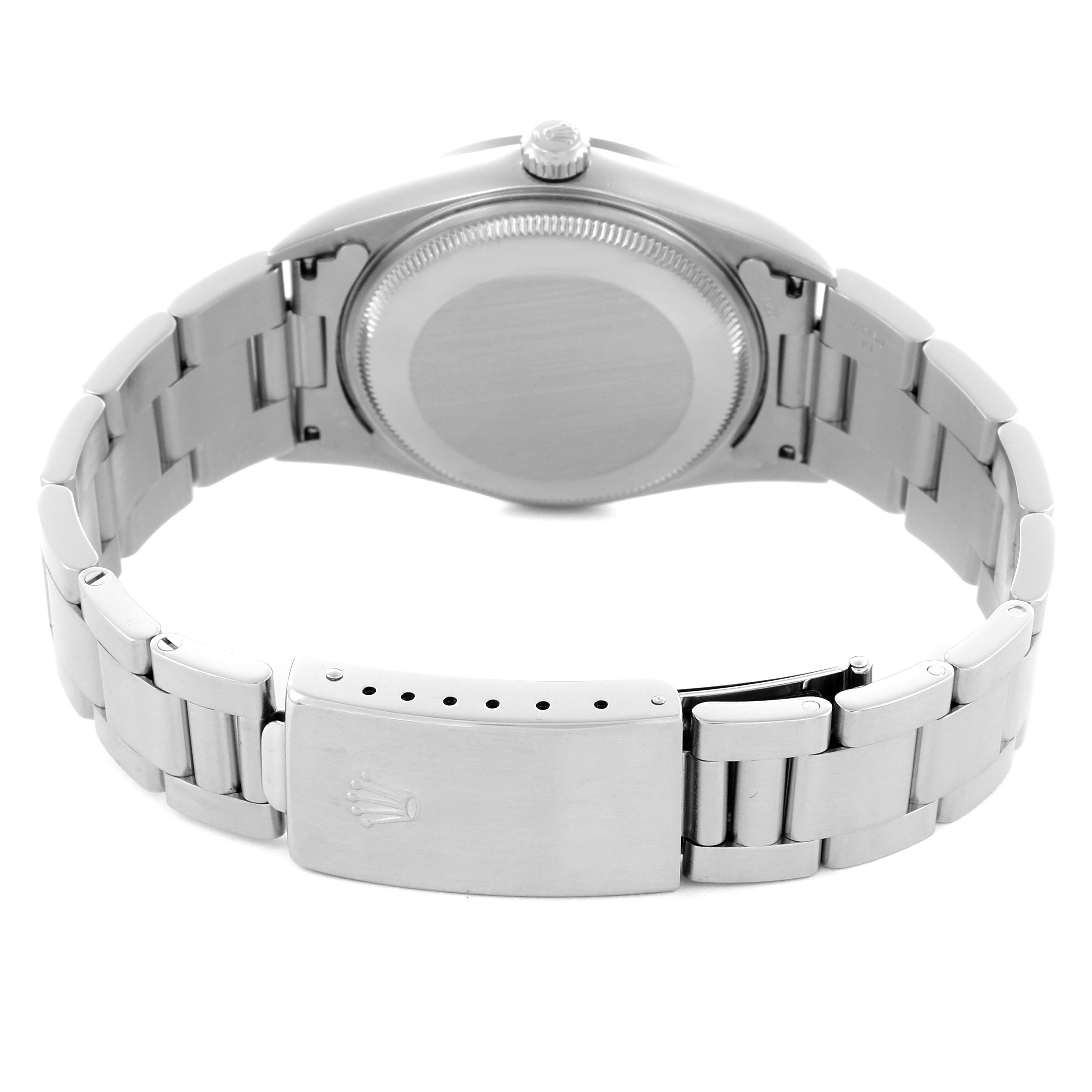 The Rolex Air-King 14000M Men's Stainless Steel Silver Dial 14000M Men's Stainless Steel Silver Dial watch is shown from the back, featuring the case back and part of the bracelet with the clasp.