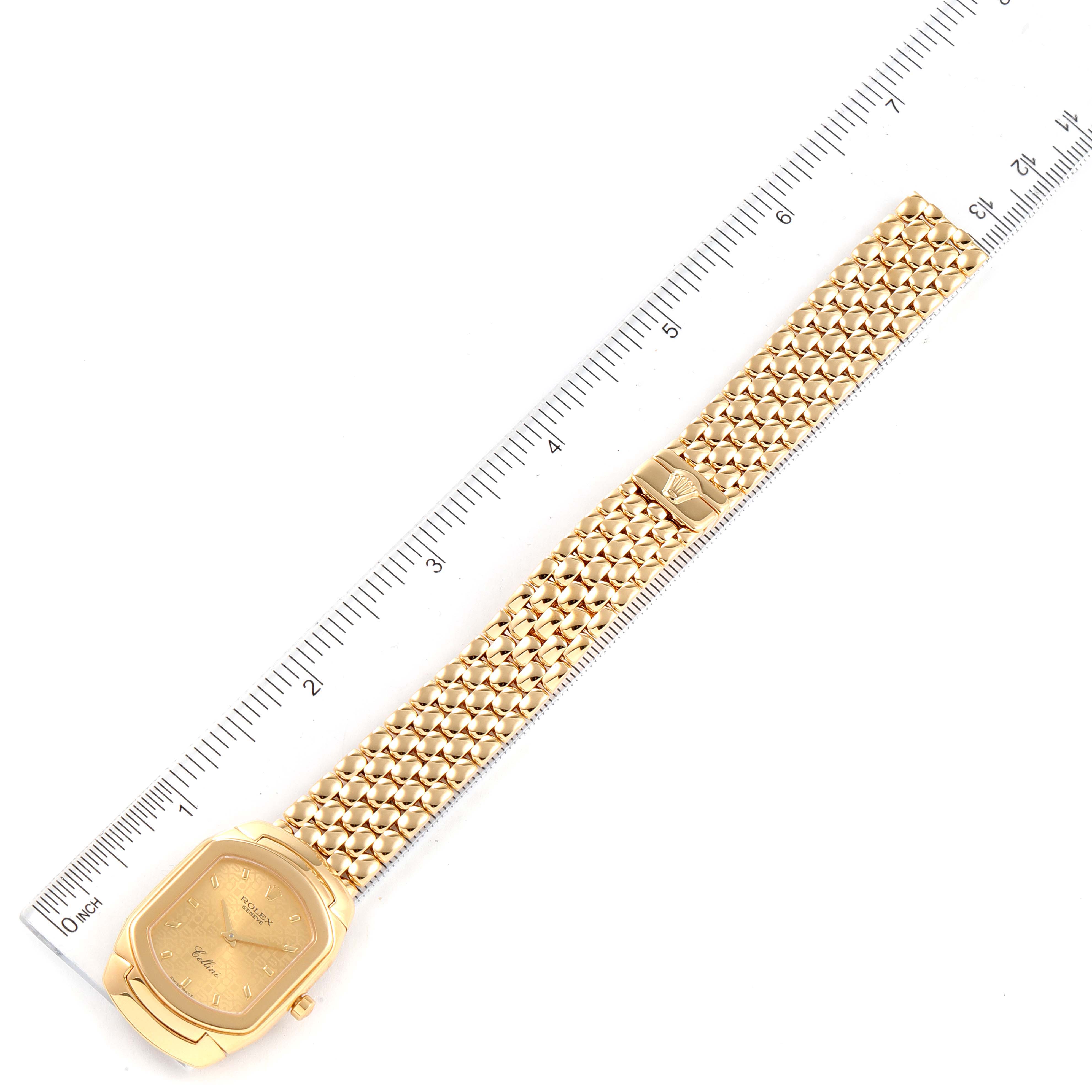 The Rolex Cellini 6691 Women's Yellow Gold Champagne Dial 6691 Women's Yellow Gold Champagne Dial watch is shown from a top-down angle, displaying its face, bracelet, and clasp alongside a ruler for scale.
