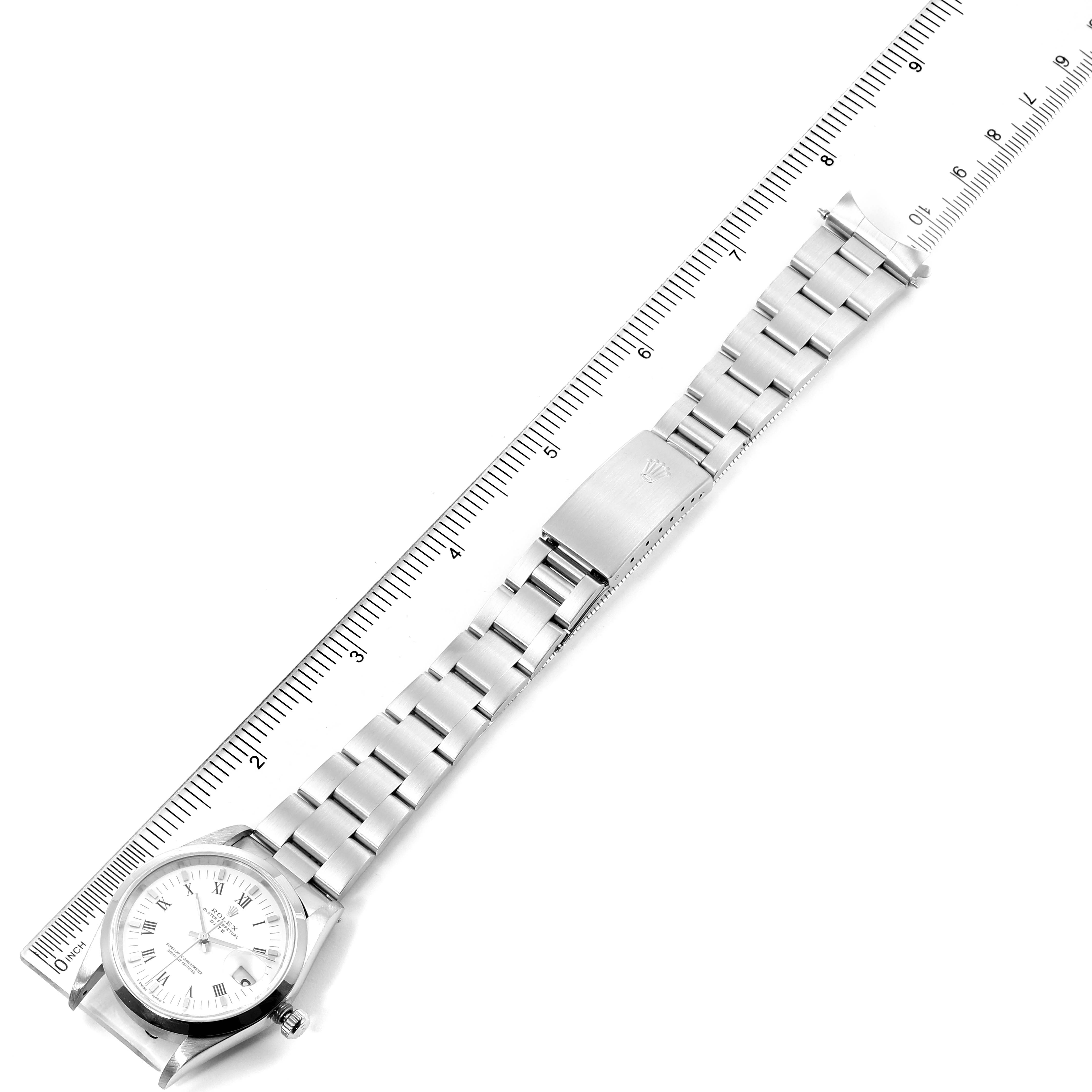 The image shows a Rolex Date 15200 Men's Stainless Steel White Dial 15200 Men's Stainless Steel White Dial watch laid flat with its bracelet extended next to a ruler.