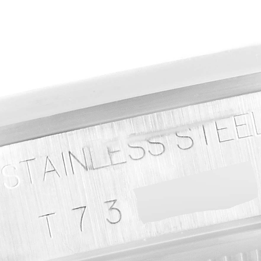 This close-up image shows the stainless steel case and part of the serial number of a Rolex Date 15200 Men's Stainless Steel White Dial 15200 Men's Stainless Steel White Dial model watch.
