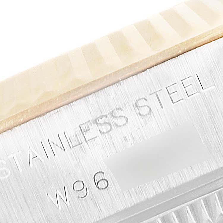 The image shows a close-up of the stainless steel case and fluted bezel of a Rolex Datejust 69173 Women
s Steel and Gold (two tone) Champagne Dial 69173 Women
s Steel and Gold (two tone) Champagne Dial watch.