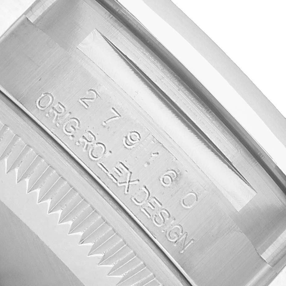 The image shows a close-up of the case back edge of a Rolex Datejust 279160 Women's Stainless Steel Pink Dial, highlighting engravings and serrated edges.