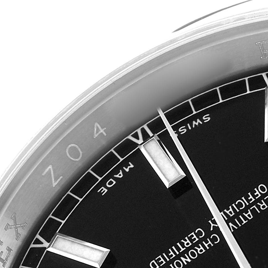 The image shows a close-up of the dial's edge and hour marker of a Rolex Datejust 116200 Men's Stainless Steel Black Dial, with partial bezel and branding visible.