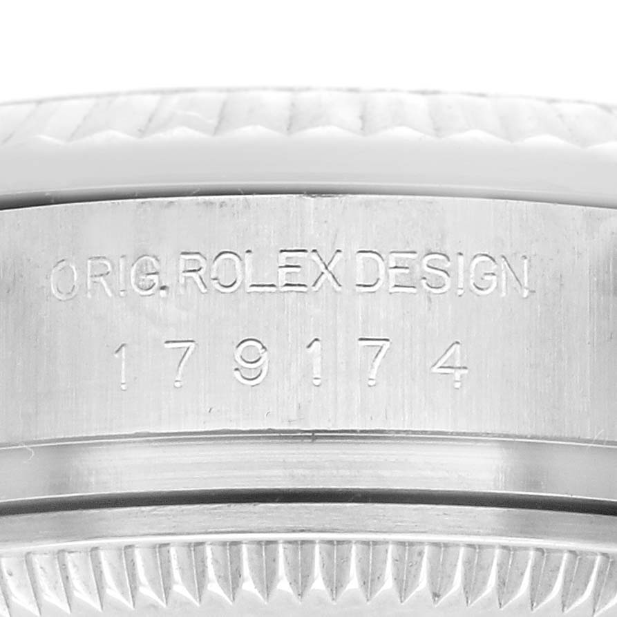 The image shows a close-up of the side engraving on a Rolex Datejust 179174 Women's Stainless Steel Black Dial 179174 Women's Stainless Steel Black Dial watch, featuring the model number and design details.