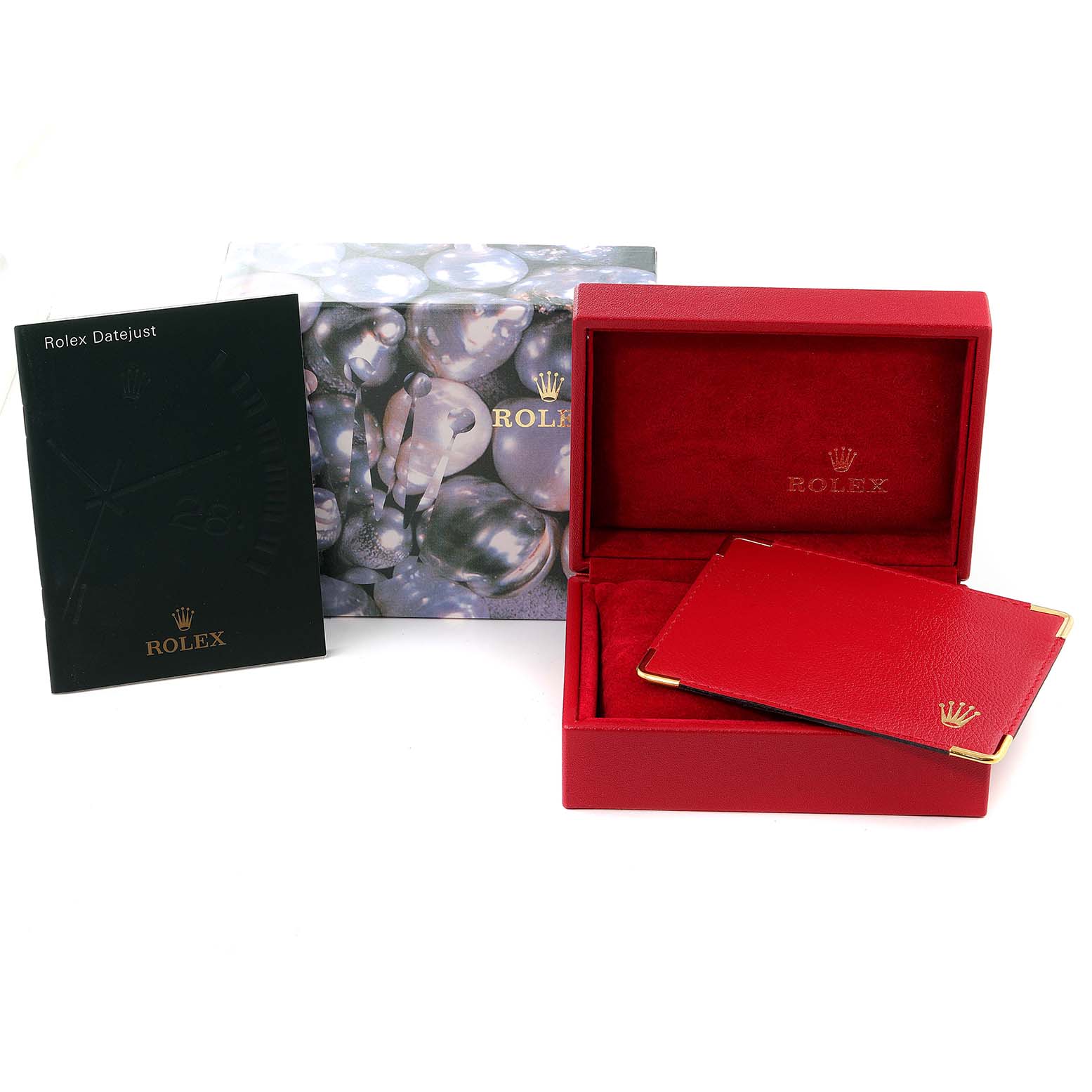 The image shows the accessories for a Rolex Datejust 79174 Women
s Stainless Steel Mother of Pearl Dial 79174 Women
s Stainless Steel Mother of Pearl Dial, including its box, warranty card holder, and manual.