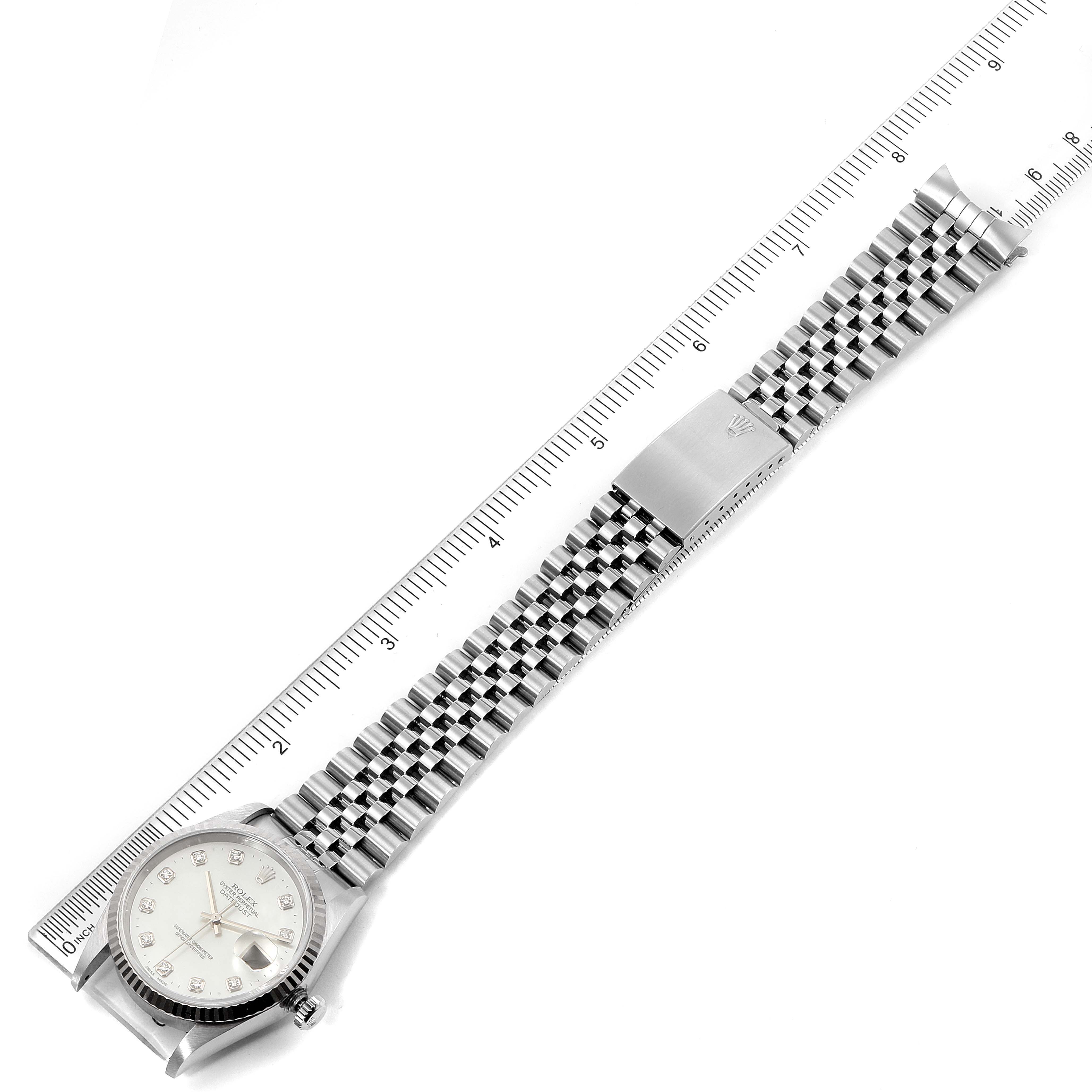 The image shows a top-down view of a Rolex Datejust 16234 Men
s Stainless Steel Mother of Pearl Dial 16234 Men
s Stainless Steel Mother of Pearl Dial watch, featuring the face, bracelet, and clasp, aligned next to a ruler.
