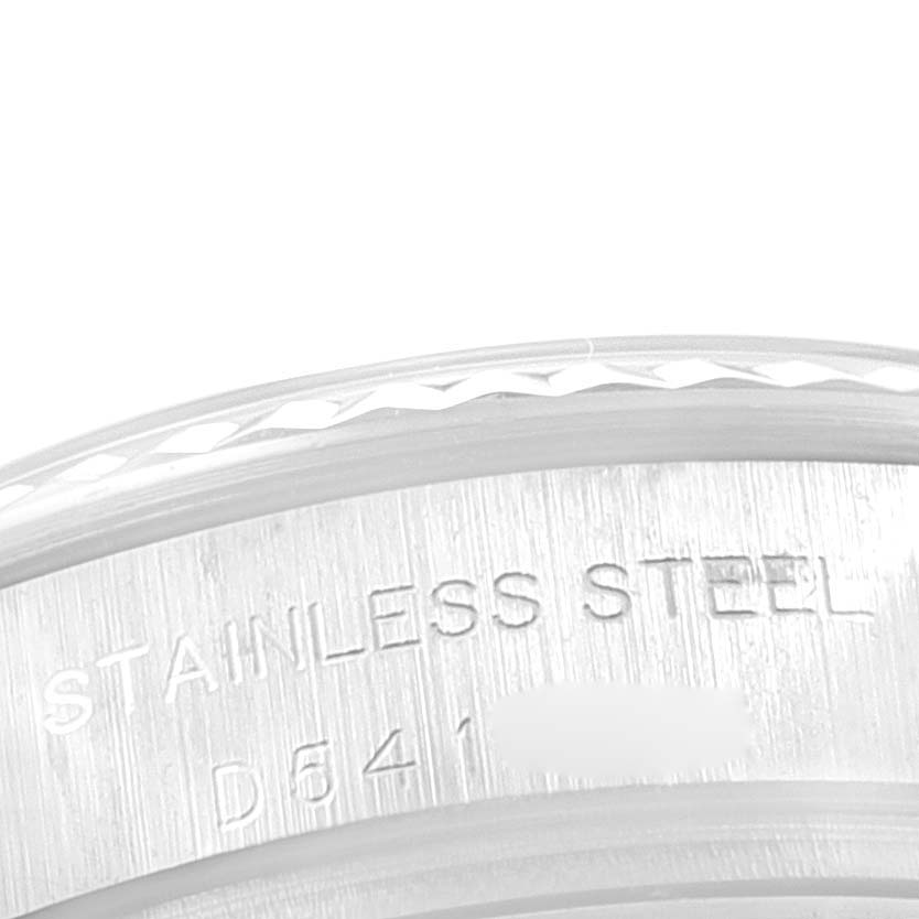 The image shows a close-up of the stainless steel bezel and case side of a Rolex Datejust 179174 Women
s Stainless Steel Silver Dial 179174 Women
s Stainless Steel Silver Dial watch, revealing part of its engraved text.