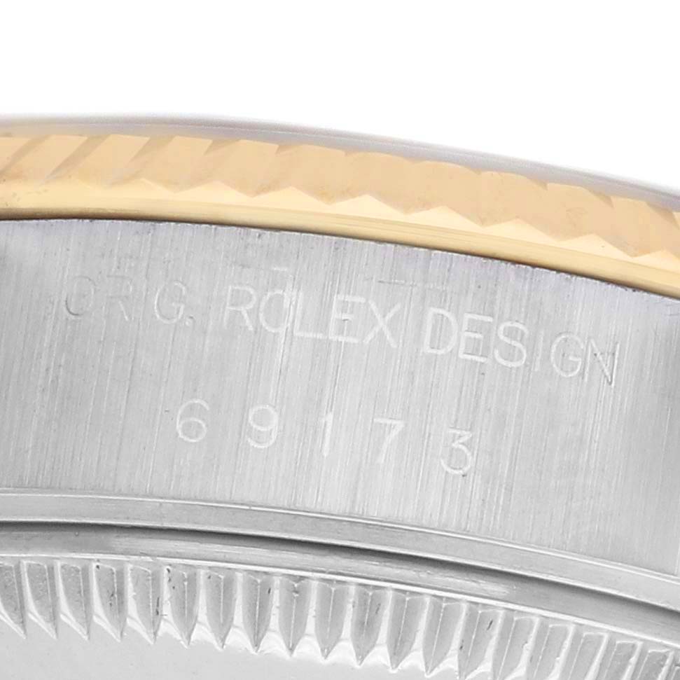 The image shows a close-up of the edge and part of the case with a fluted bezel of the Rolex Datejust 69173 Women's Steel and Gold (two tone) Champagne Dial watch.
