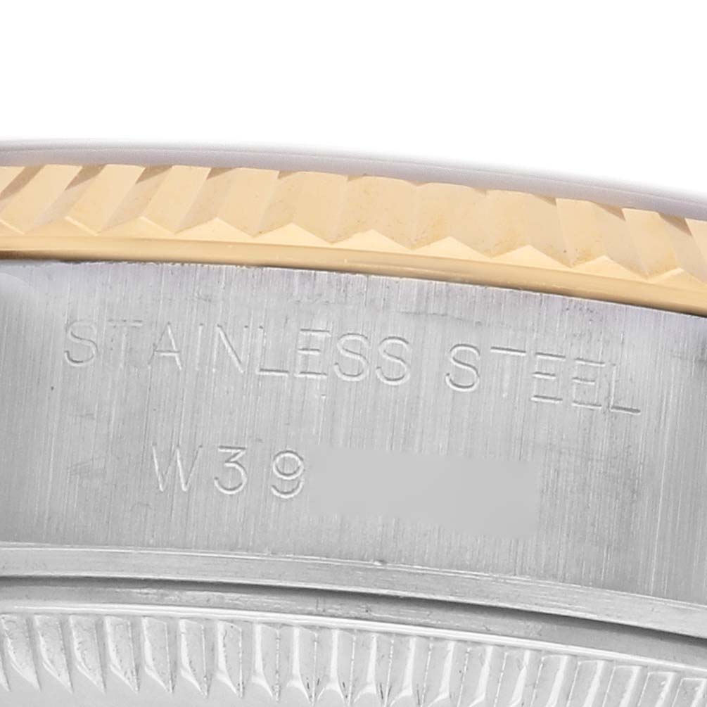 The image shows a close-up of the Rolex Datejust 69173 Women's Steel and Gold (two tone) Champagne Dial's fluted bezel and part of the case with engraved markings.