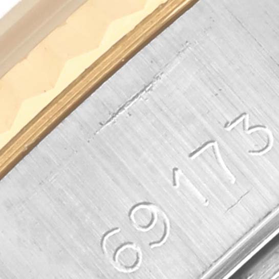 The image shows a close-up of the Rolex Datejust 69173 Women's Steel and Gold (two tone) Champagne Dial 69173 Women's Steel and Gold (two tone) Champagne Dial model's bracelet section, highlighting the serial number and metal detailing.