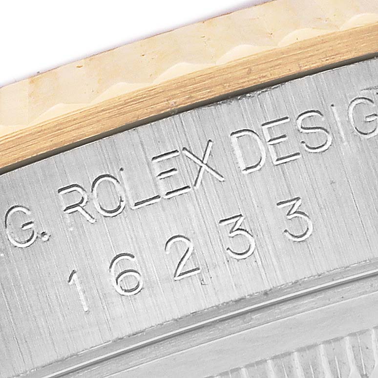 The image shows a close-up of the engraved inner bezel of a Rolex Datejust 16233 Men's Steel and Gold (two tone) White Dial 16233 Men's Steel and Gold (two tone) White Dial model.