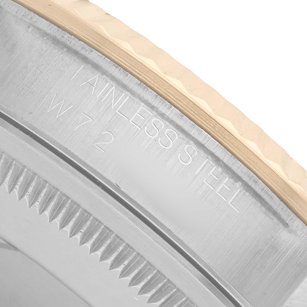 The image shows a close-up of the bezel and part of the case back of a Rolex Datejust 16233 Men's Steel and Gold (two tone) White Dial, highlighting the "STAINLESS STEEL" engraving.