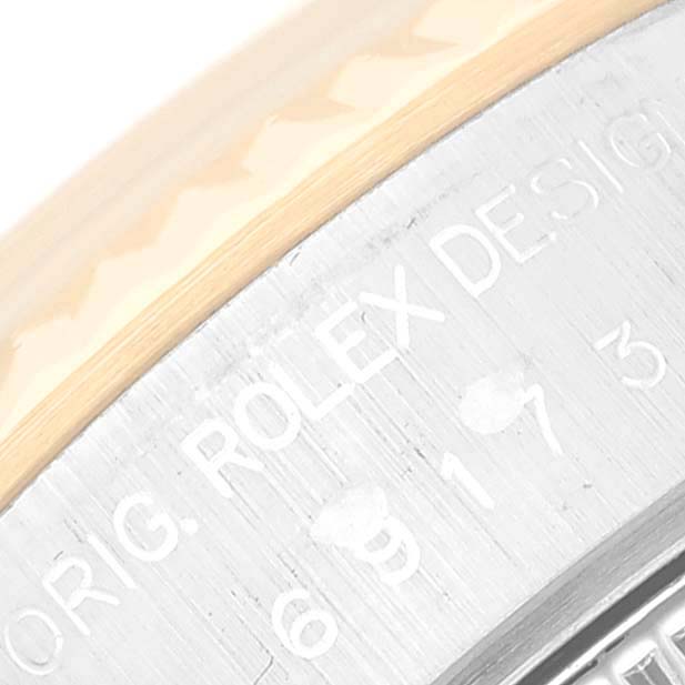 This image shows a close-up of the side view of a Rolex Datejust 69173 Women's Steel and Gold (two tone) White Dial 69173 Women's Steel and Gold (two tone) White Dial model, highlighting part of the bezel and the engraved text.