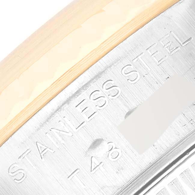 The image shows a close-up angle of the stainless steel casing of a Rolex Datejust 69173 Women's Steel and Gold (two tone) White Dial 69173 Women's Steel and Gold (two tone) White Dial watch with some engraved markings.