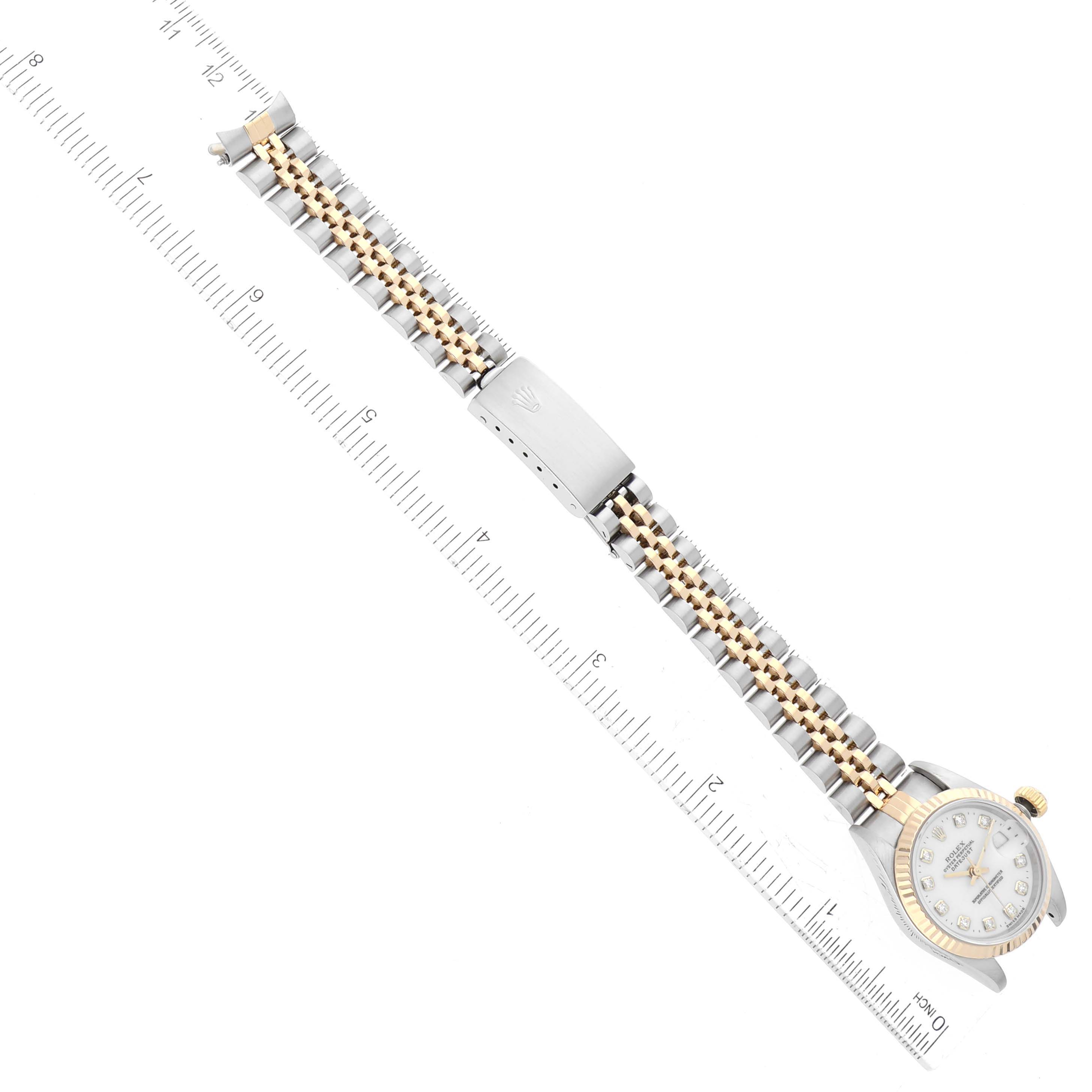The image shows a Rolex Datejust 69173 Women's Steel and Gold (two tone) White Dial 69173 Women's Steel and Gold (two tone) White Dial watch laid flat with a focus on the entire bracelet and case along a ruler for measurement.