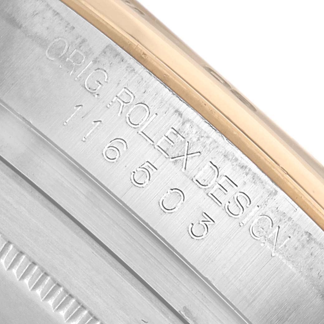 This image shows a close-up of the Rolex Daytona 116503 Men's Steel and Gold (two tone) Black Dial watch case, highlighting engraved text on the side.