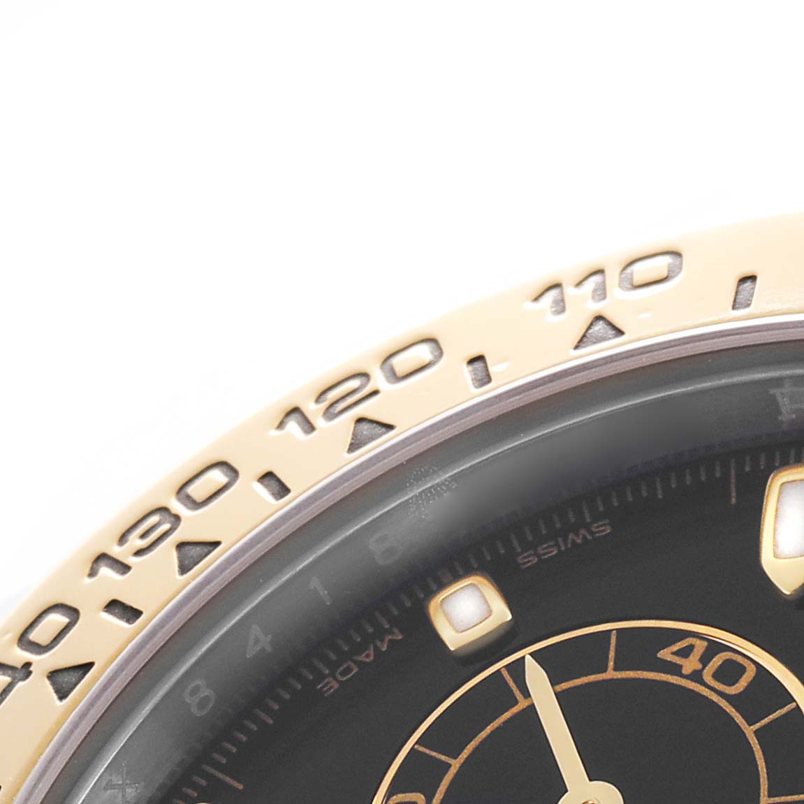 The image shows a close-up of the bezel and part of the dial of a Rolex Daytona 116503 Men's Steel and Gold (two tone) Black Dial watch, focusing on the tachymetric scale.