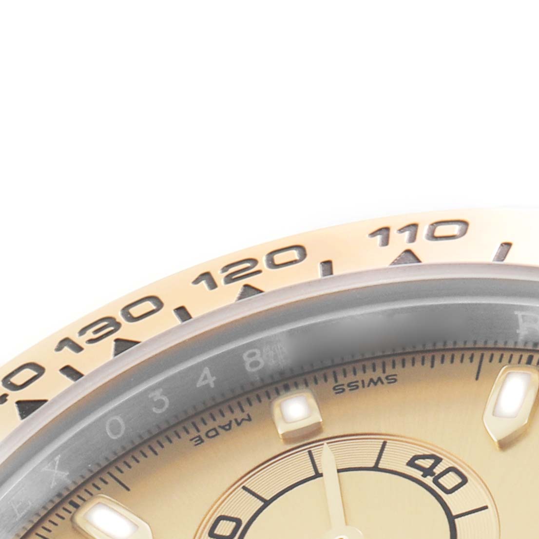 The image shows a close-up of the Rolex Daytona 116503 Men's Steel and Gold (two tone) Champagne Dial's bezel with tachymetric scale and part of the dial.