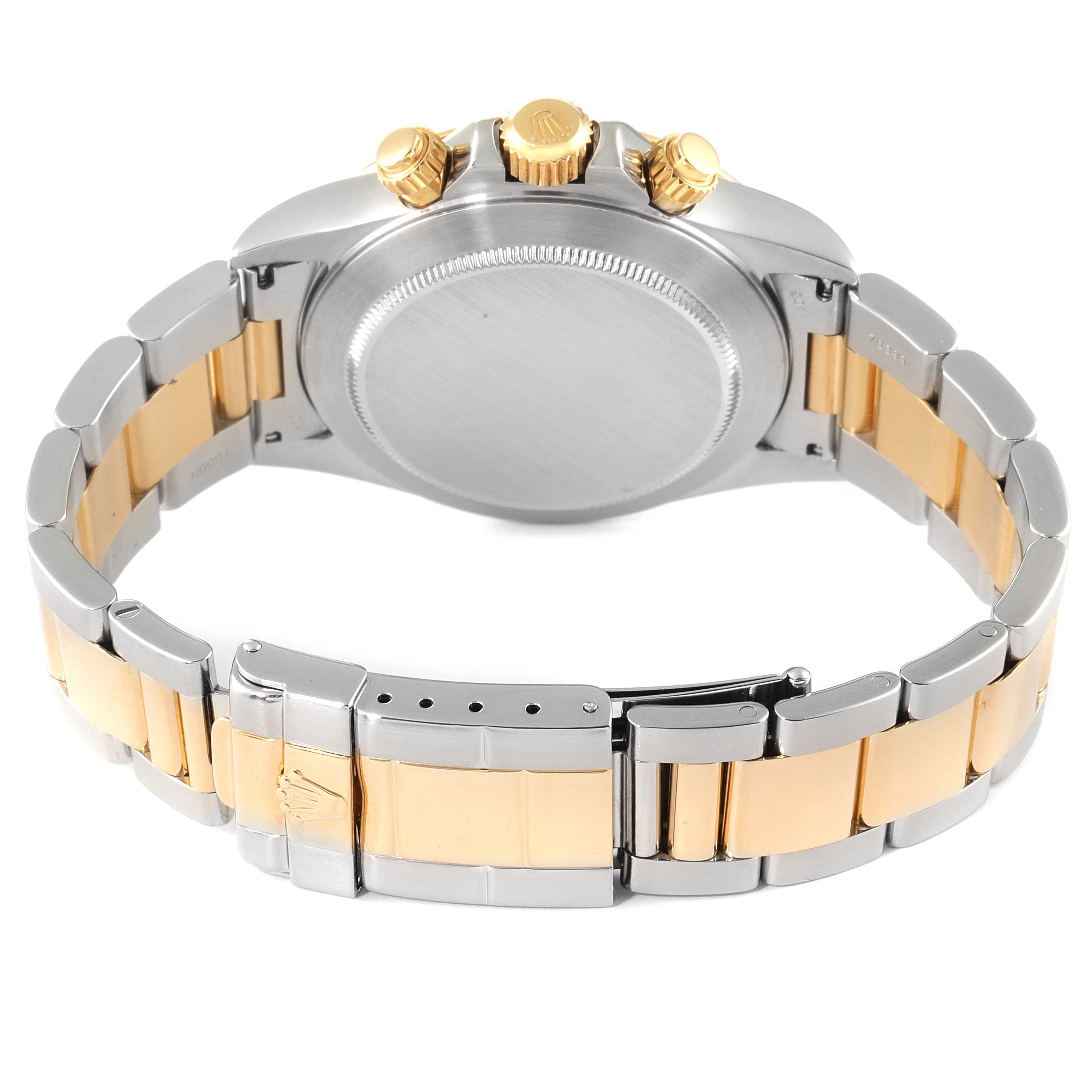 The image shows the back of a Rolex Daytona 16523 Men
s Steel and Gold (two tone) White Dial 16523 Men
s Steel and Gold (two tone) White Dial watch, highlighting its bracelet, clasp, and crown.