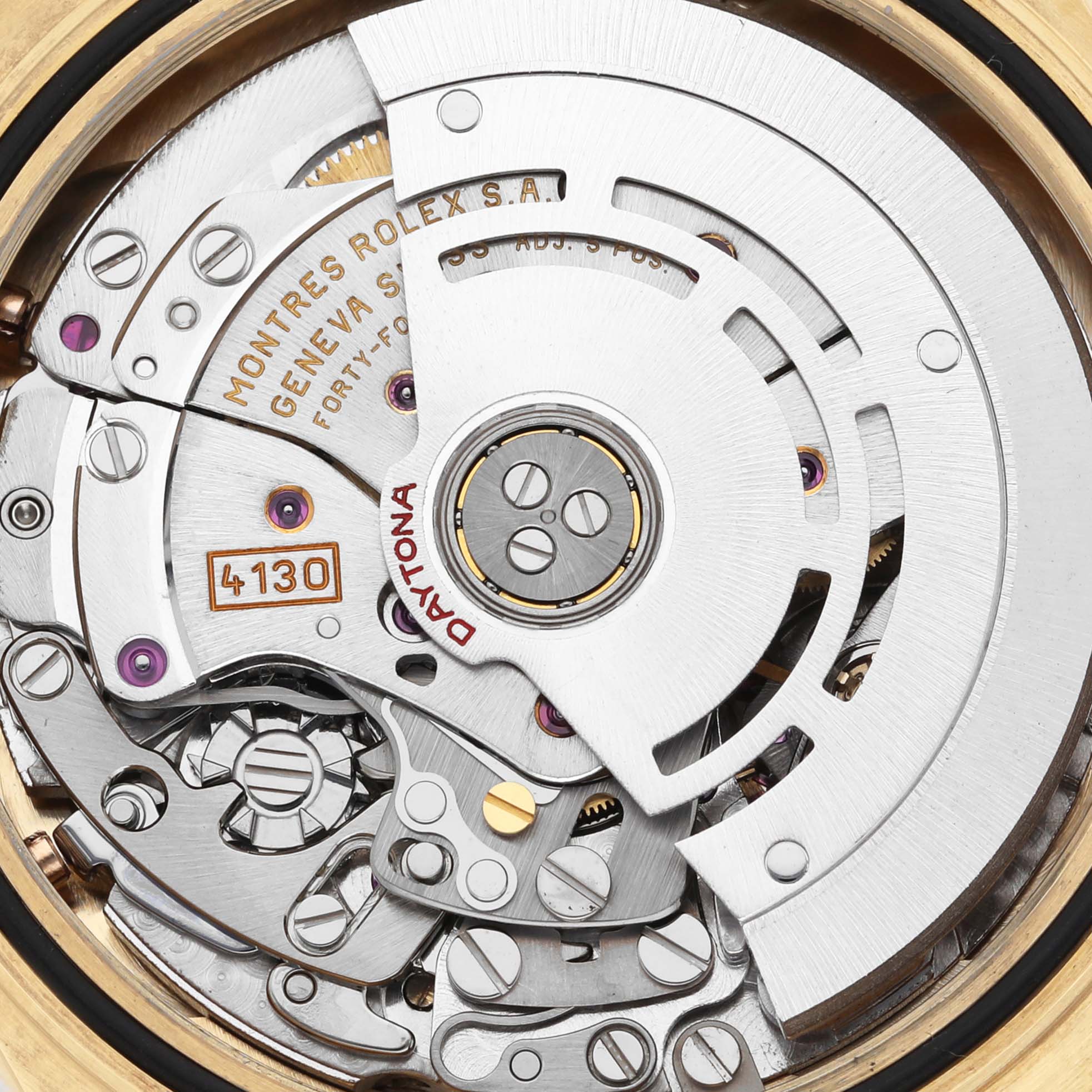 The image shows the movement mechanism of a Rolex Daytona 116518 Men's Yellow Gold Mother of Pearl Dial 116518 Men's Yellow Gold Mother of Pearl Dial, displaying its intricate gears and rotor.