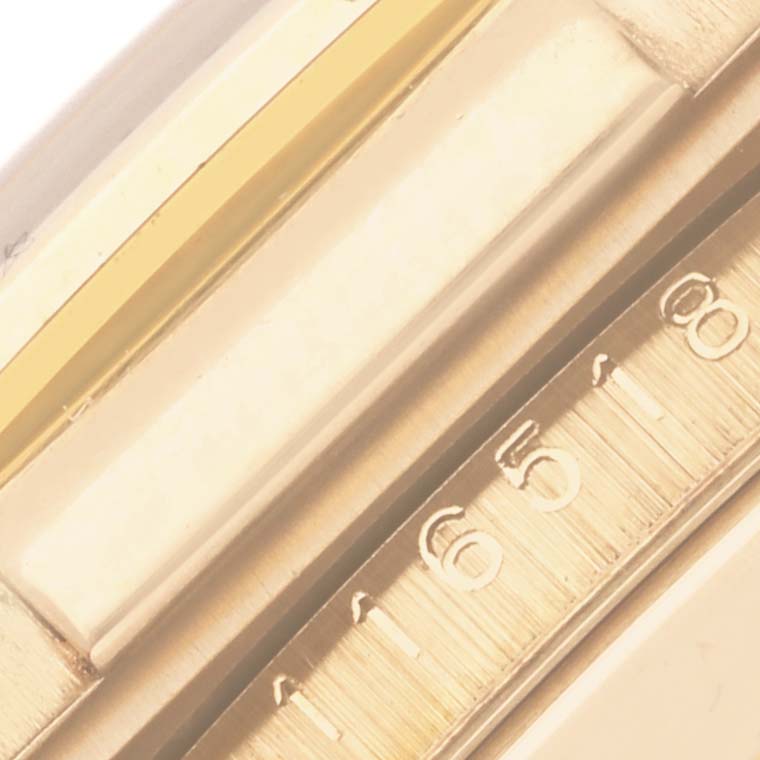 The image shows a close-up of the bezel with part of the tachymetric scale of a Rolex Daytona 116518 Men's Yellow Gold Mother of Pearl Dial 116518 Men's Yellow Gold Mother of Pearl Dial watch.