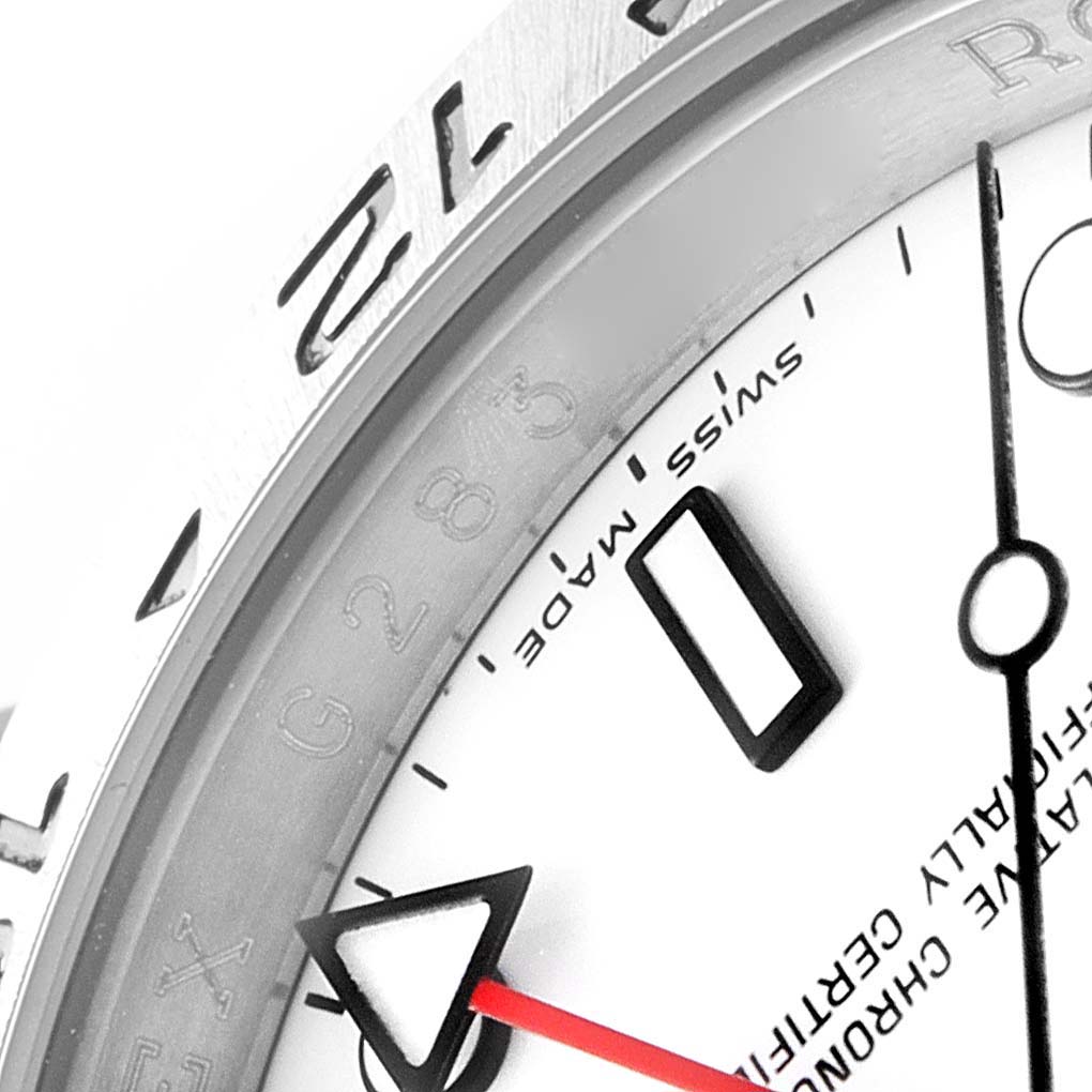 This close-up angle of the Rolex Explorer 16570 Men's Stainless Steel White Dial 16570 Men's Stainless Steel White Dial model shows part of the bezel, dial, and arrow-shaped hand.