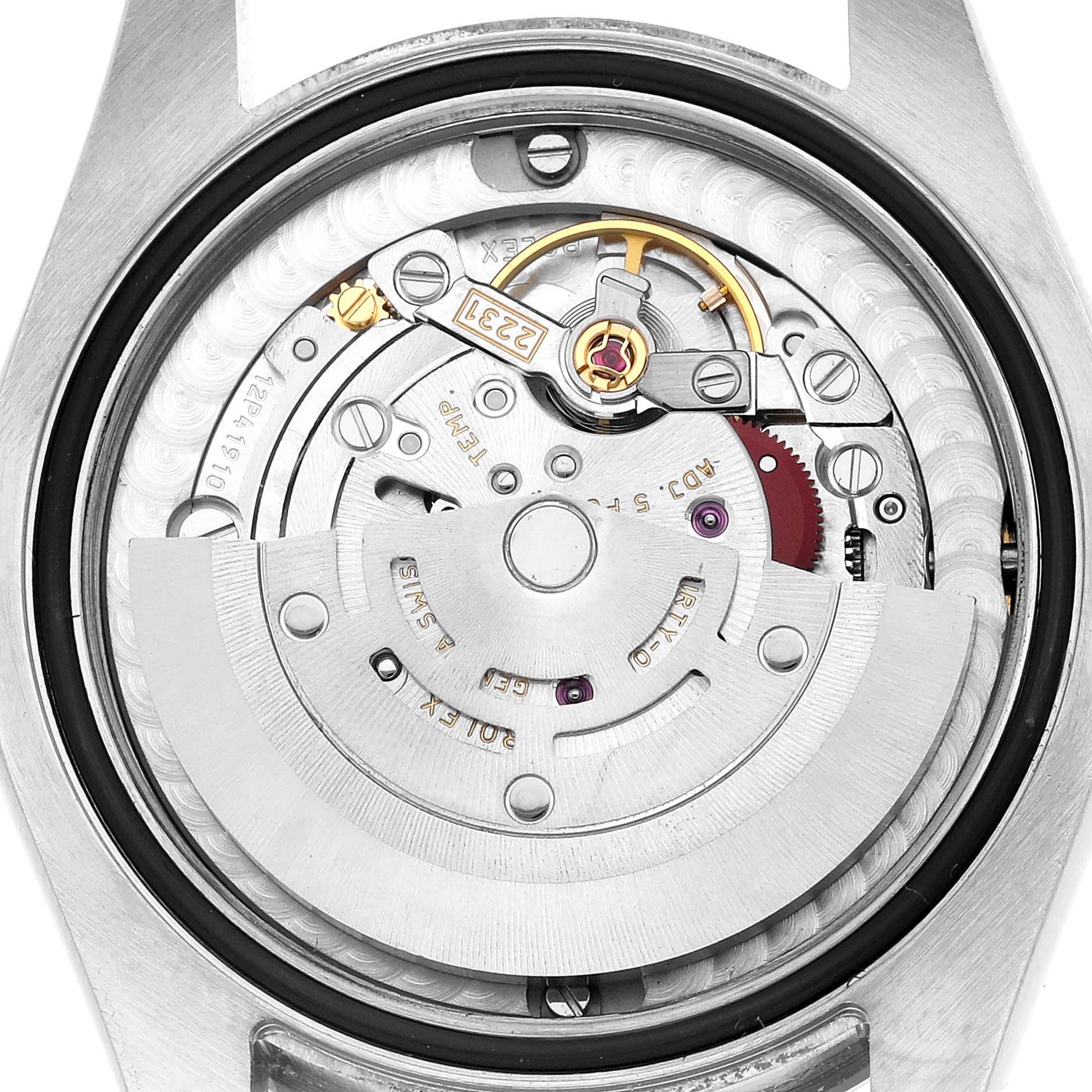 The image shows the internal movement of a Rolex Mid-Size 177200 Women's Stainless Steel Blue Dial watch from a rear angle, highlighting the rotor and mechanical components.