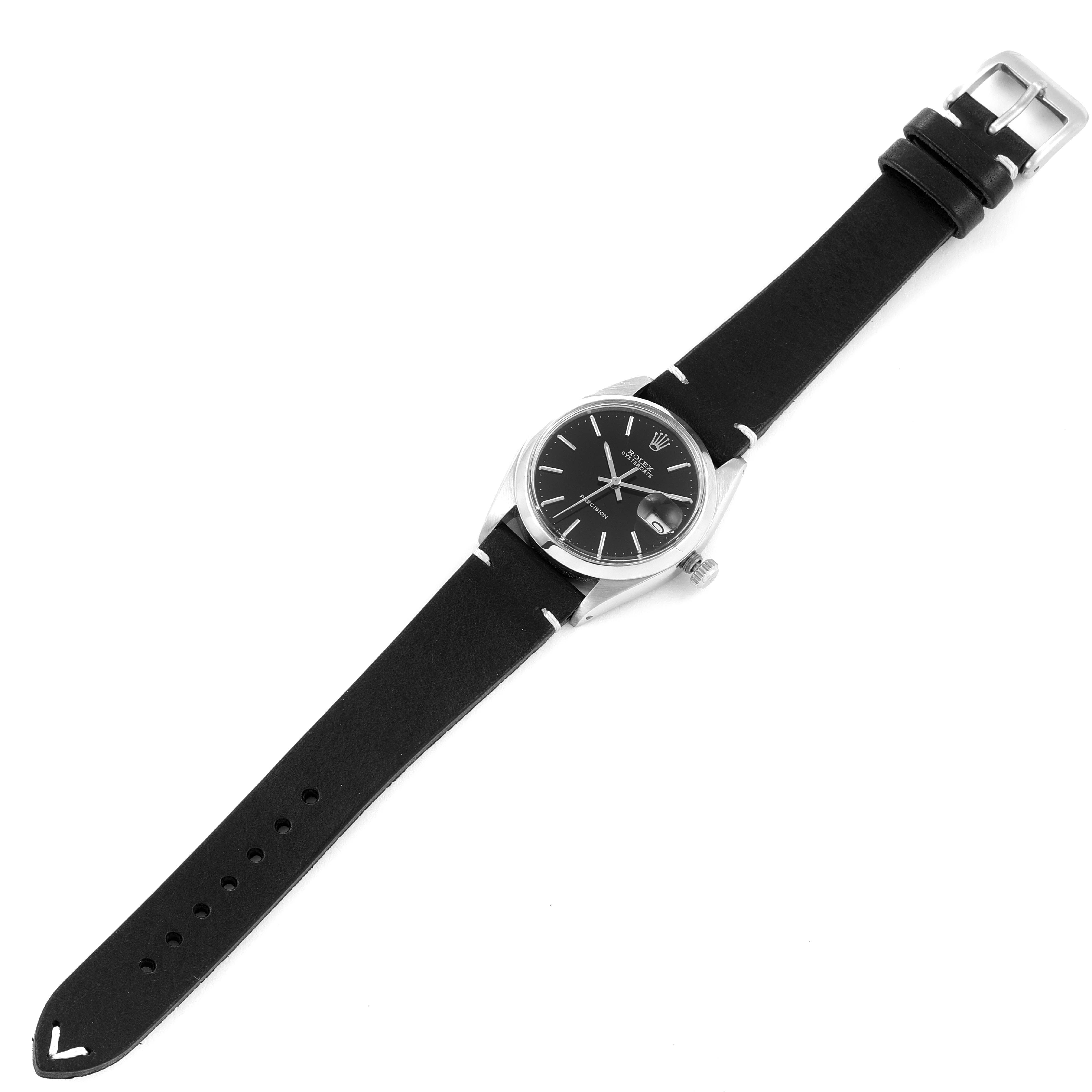 This image shows a frontal view of a Vintage Collection Rolex watch with a black strap and a visible buckle.