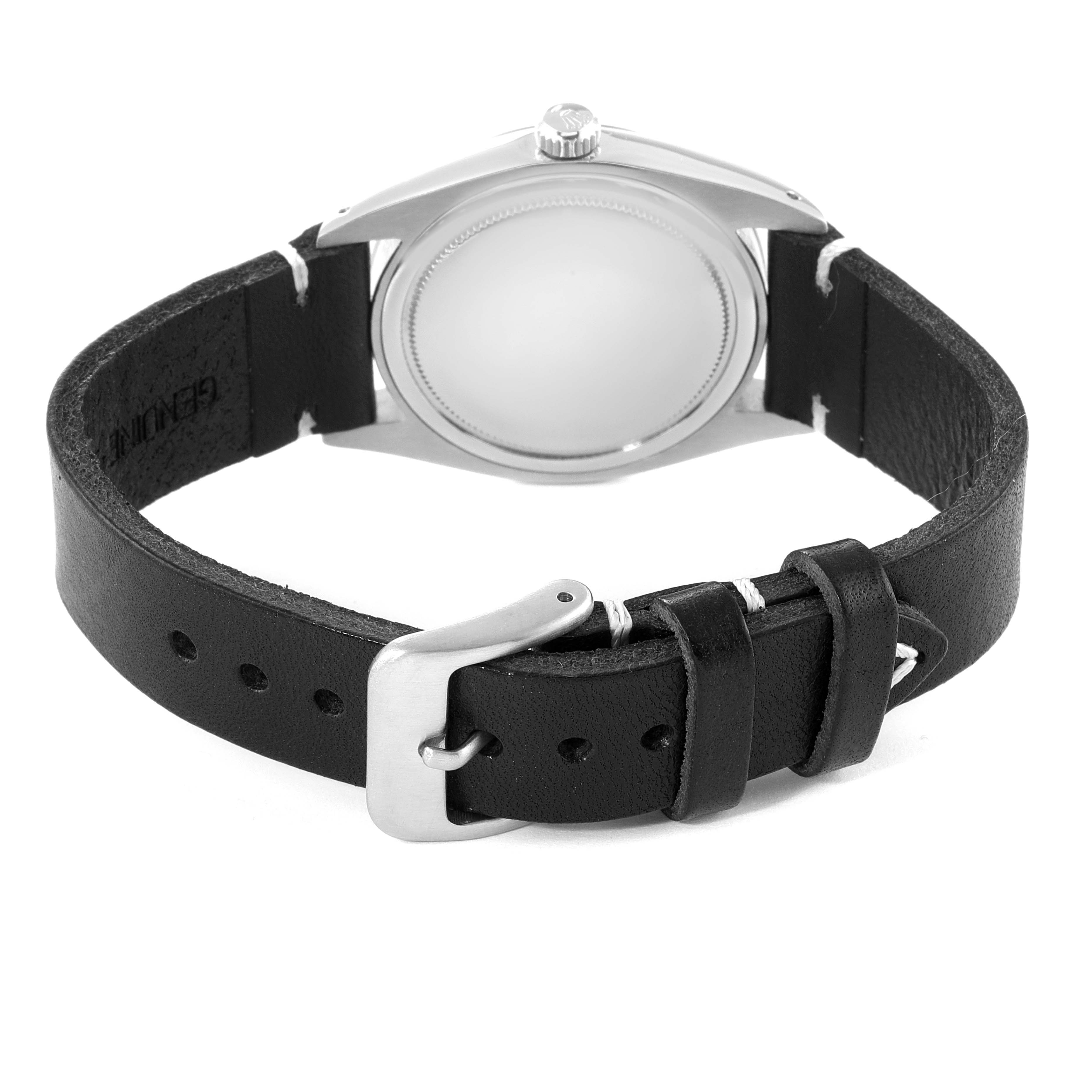 The image shows the back view of a Vintage Collection Rolex watch with a black leather strap and a silver buckle.