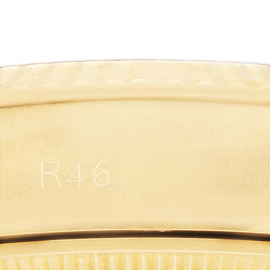 The image shows a close-up of the edge and part of the band of a Rolex President 69178 Women's Yellow Gold Champagne Dial watch, highlighting the engraving detail.