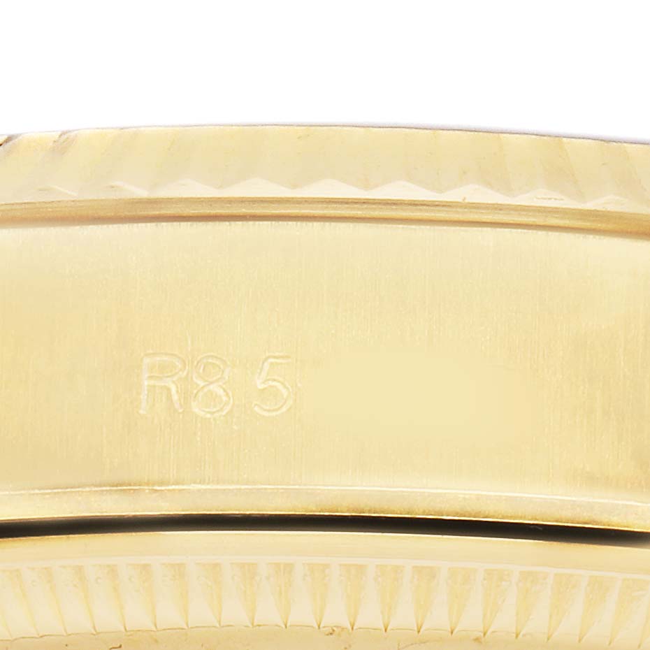The image shows a close-up of the case side and edge of the bezel of a Rolex President 69178 Women's Yellow Gold Champagne Dial model, highlighting engraved details.