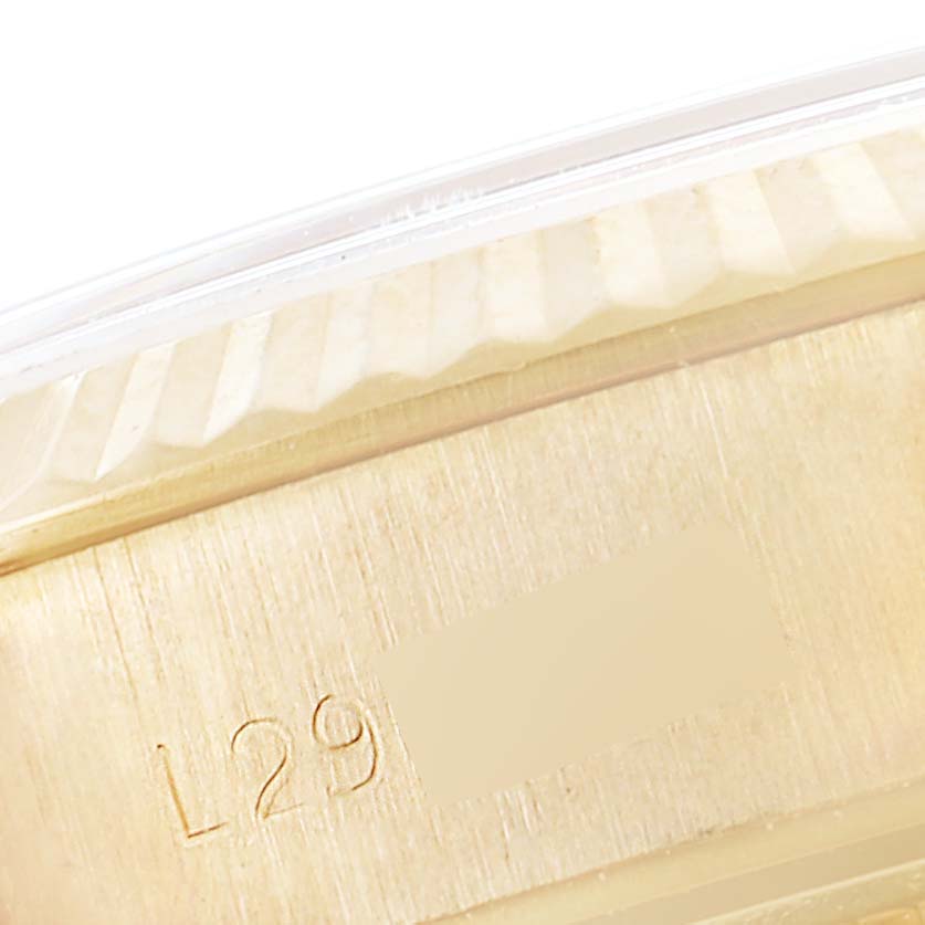 This image shows a close-up of the fluted bezel and serial number engraved on a Rolex President 69178 Women
s Yellow Gold Champagne Dial 69178 Women
s Yellow Gold Champagne Dial model watch.