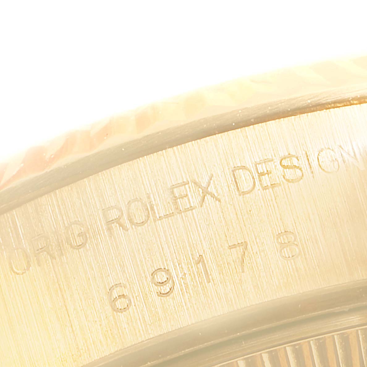 This is a close-up shot of the Rolex President 69178 Women's Yellow Gold Champagne Dial 69178 Women's Yellow Gold Champagne Dial model watch showing the engraved text.